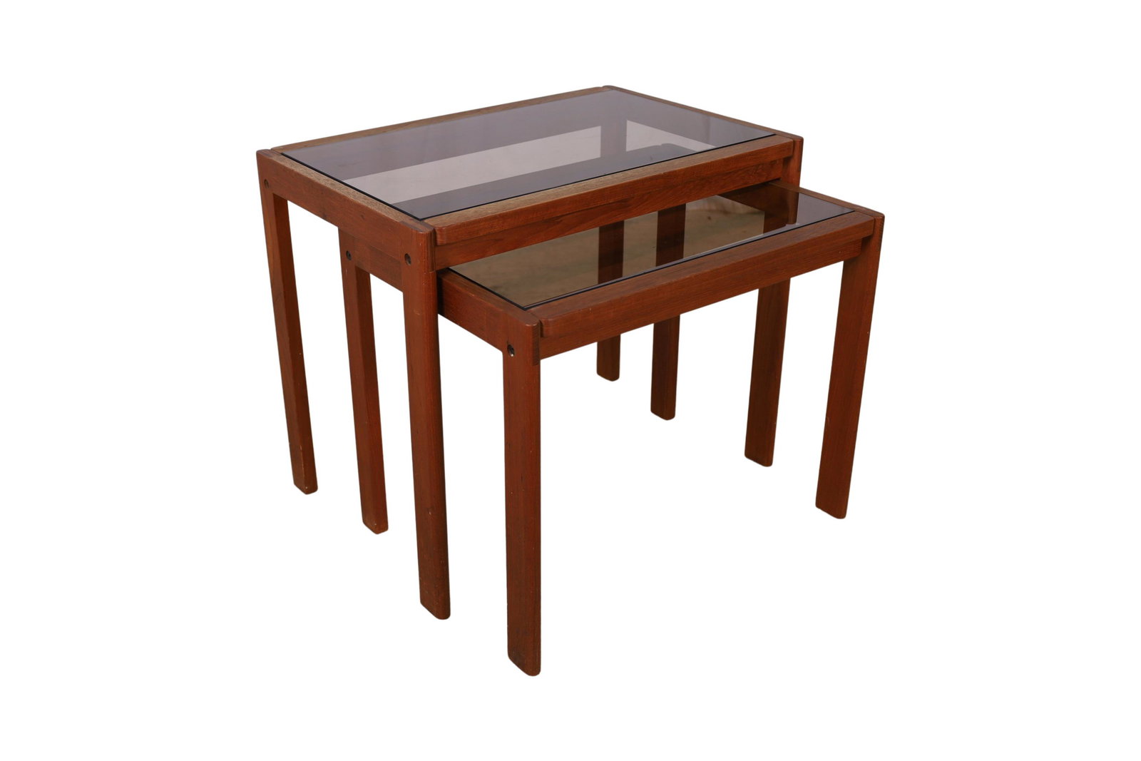 Nest of 2 Teak and Glass Tables: Description - Nest of 2 teak and glass tables. Dimensions - larger- 20" x 24"