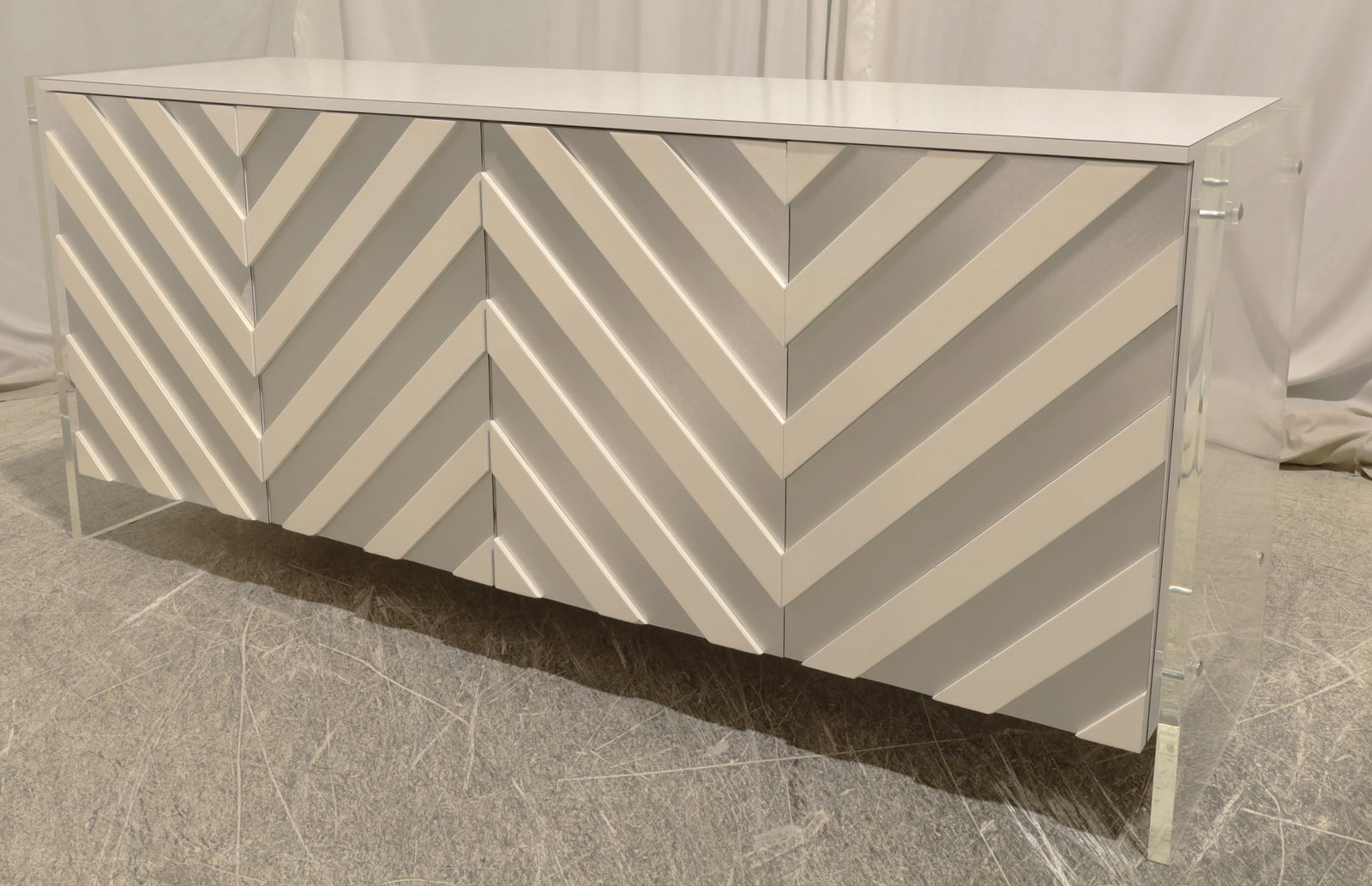 Chevron Style Credenza with Lucite Sides: A chevron pattern credenza with lucite sides Dimensions:31x72x20