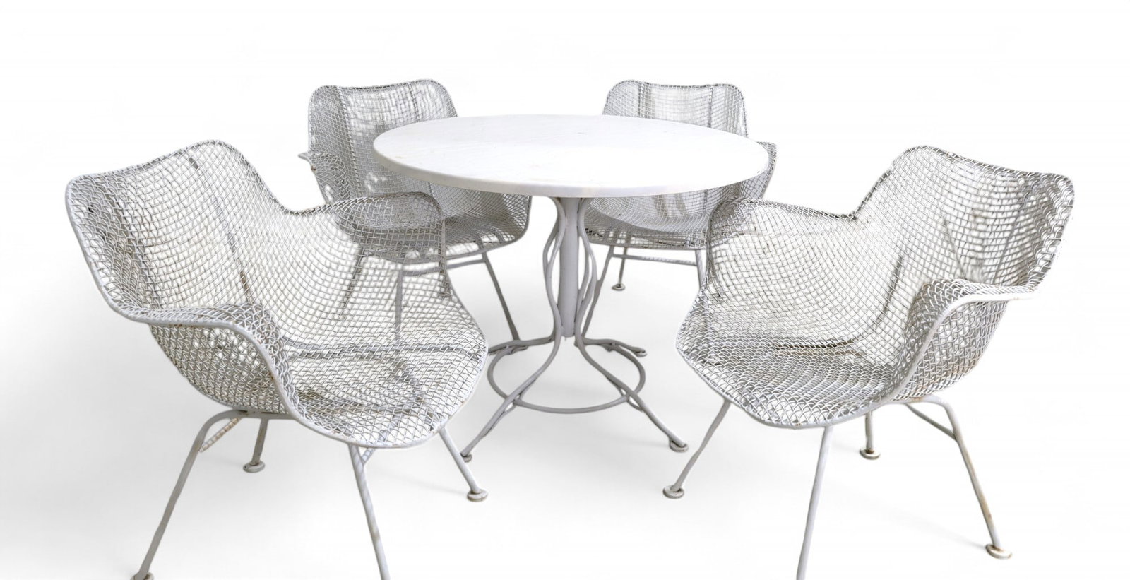 Woodard Arm Chair and Bistro Table: A Woodard bistro set, includes 4 sculpted arm armchairs and a bistro table Table Dimensions:27x36 Chair Dimensions:29x27x24