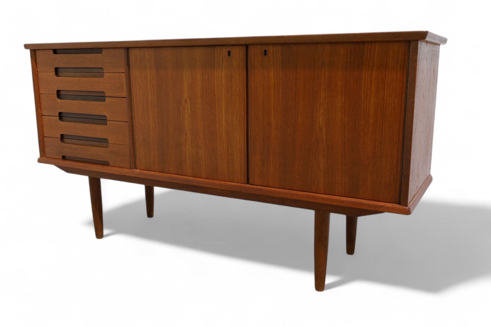 Danish Teak Credenza: A Danish teak credenza with 5 drawers and a cabinet Dimensions:32x62x18