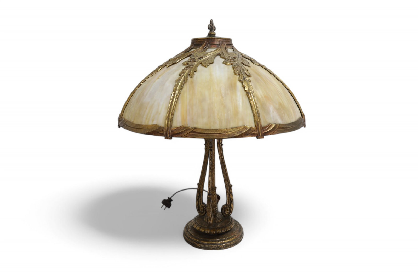 Metal Overlay Slag Glass Lamp: A table lamp with a metal overlay slag glass shade Dimensions:21x7.5 (at base) Shade is 21" D