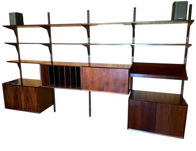 Poul Cadovius Rosewood Wall Unit: A Poul Cadovius for bay rosewood wall unit. Includes 4 cabinets, 5 posts, 10 shelves (1 desk shelf), 20 brackets Posts Dimensions:80" Cabinets:31.5x18