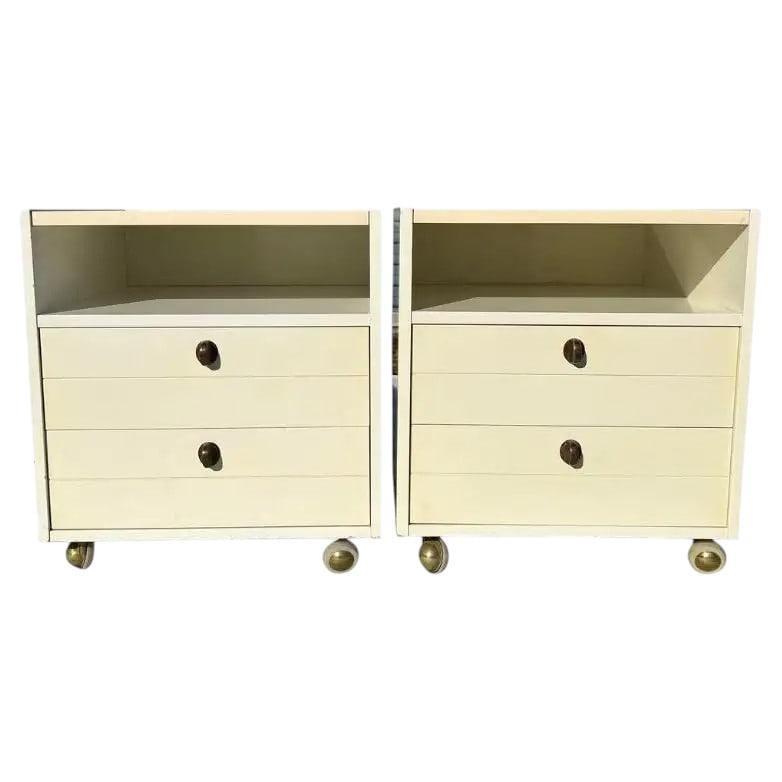 Vintage Nightstands on Casters: A pair of vintage cream colored nightstands with brass hardware on wheels Dimensions:20x18.5x18