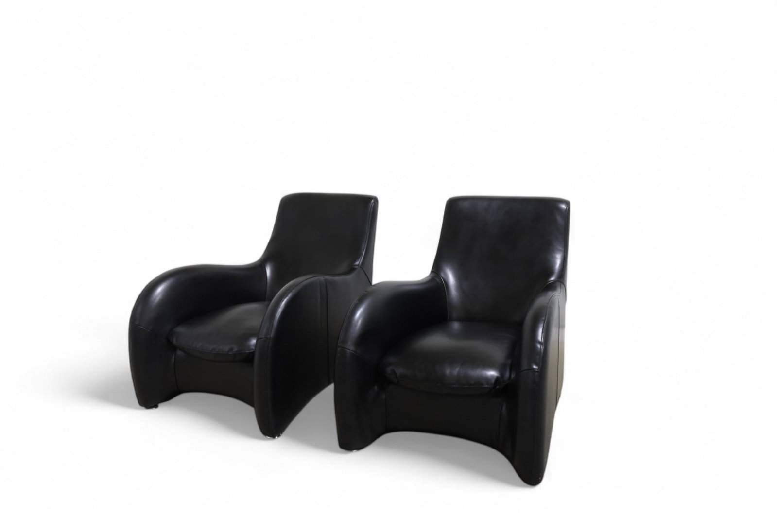 Leatherette Lounge Chairs - Pair: A pair of black leatherette lounge chairs Dimensions:33.5x28x40 Seat Height:15