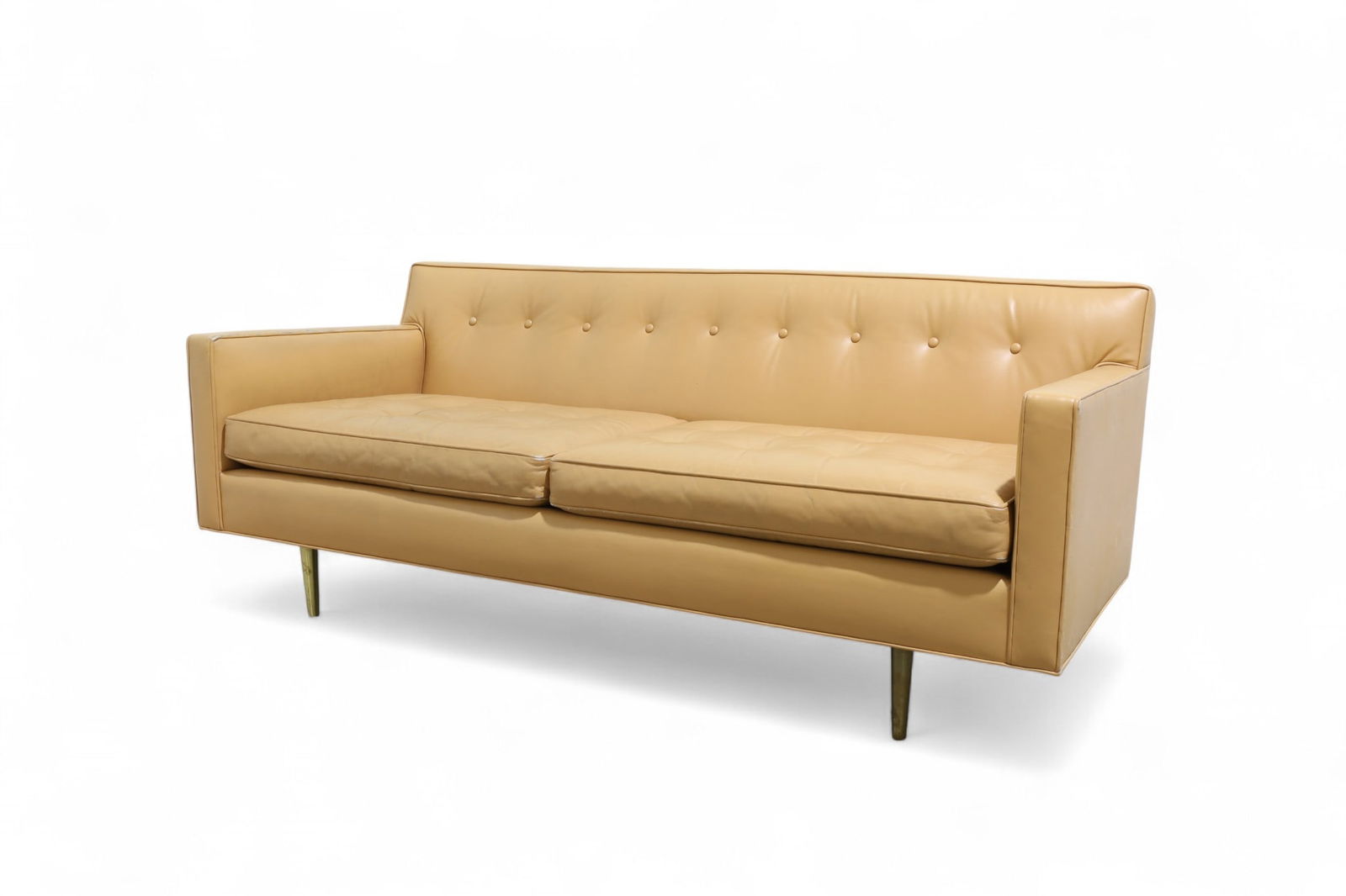 Dunbar Brass Leg Sofa: A vintage Dunbar leather sofa with brass legs Dimensions:27x70x31