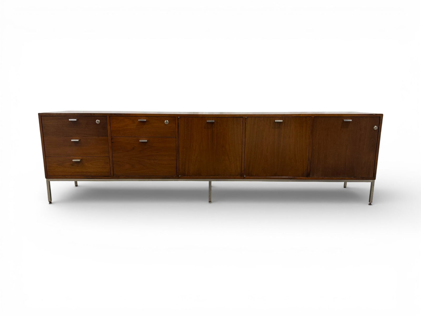 Mid Century Credenza Designed By Harvey Probber: A mid century modern walnut long credenza with 8-drawers designed by Harvey Probber. Features three locking compartments, adjustable shelves, filing storage and two cork-lined pull-out drawers. Back o