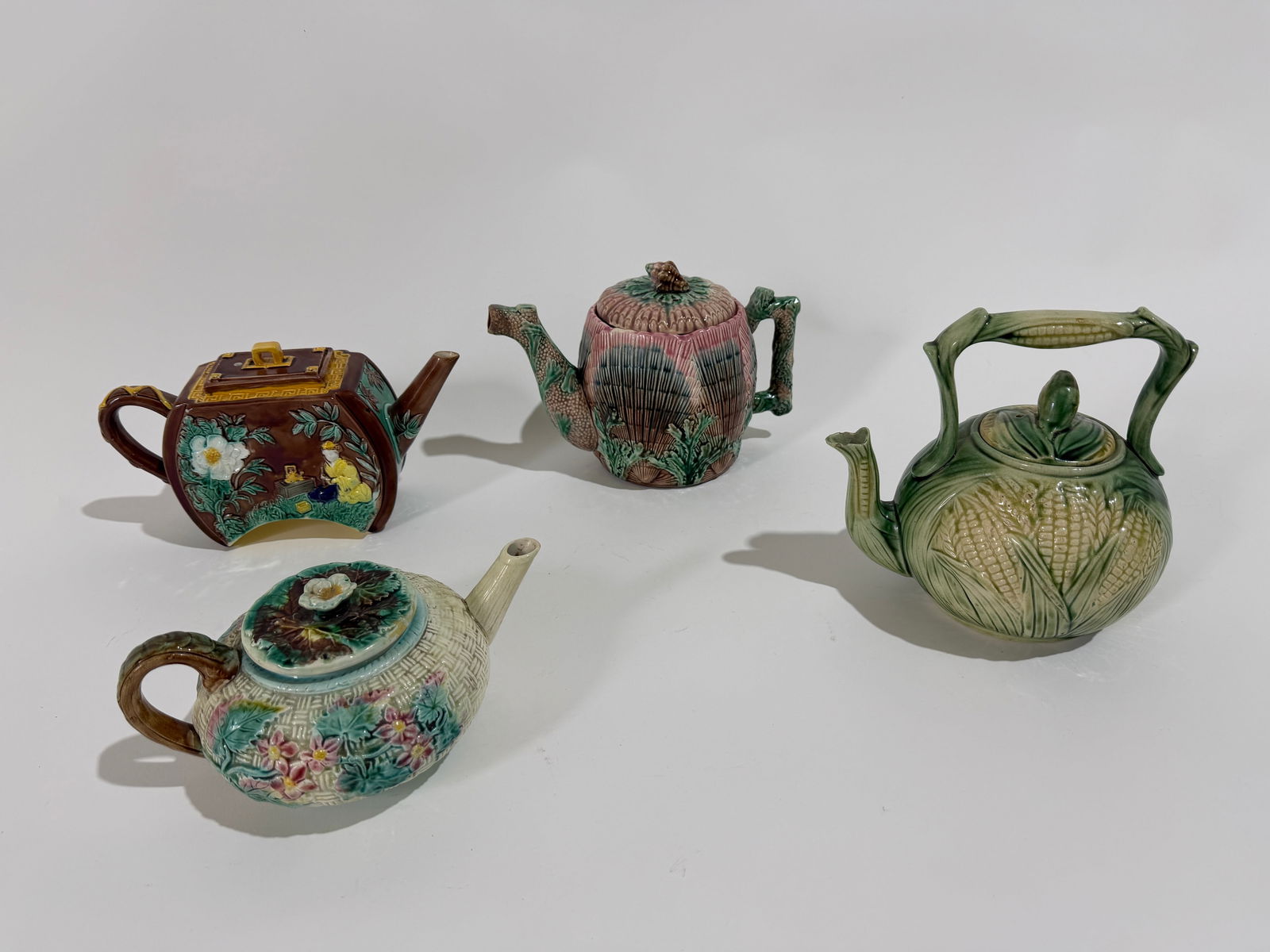 4 Vintage Majolica Tea Pots: A group of 4 assorted vintage Majolica tea pots featuring a piece from Griffin, Smith & Hill