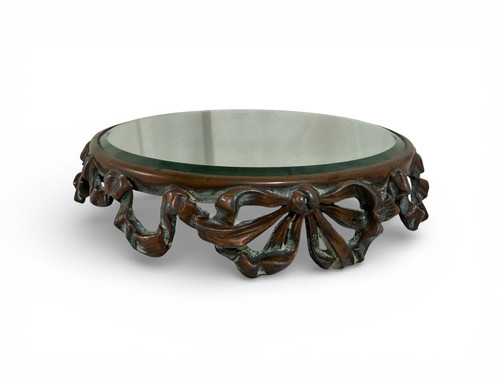 Bronze Platform Vanity Mirrored Tray: A bronze mirrored platform tray with bow details. Also known as a vanity mirror or plateau mirror. Dimensions: H:1.75" W:9" D:9"
