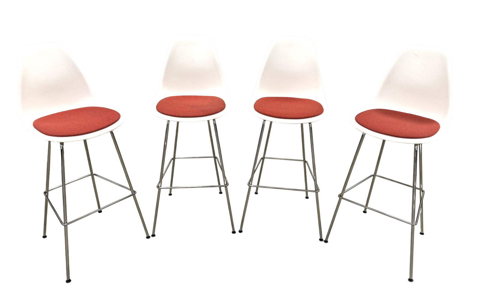 Eames Plastic Shell Stools - 4: A set of 4 marked Eames white plastic shell stools with chrome bases and red fabric seat Dimensions: H:45.5" W:18" D:20" Seat Height:32