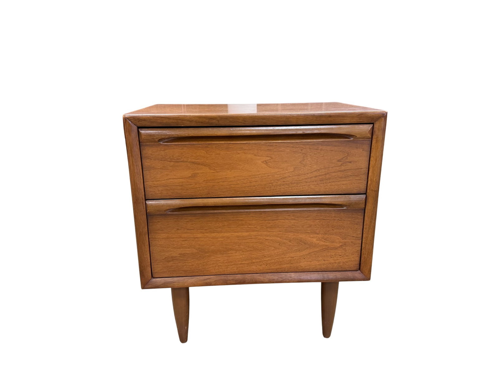 Vintage Lane Sculpted End Stand: A mid century modern Lane end stand. The single end stand is sculpted in walnut wood featuring horizontal sculpted pulls and tapered legs Dimensions: H:24" W:22" D:15"