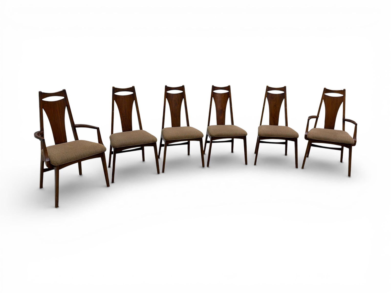 Young Manufacturing Walnut Dining Chairs | 6: A set of 6 Young Manufacturing Mid Century Walnut Dining Chairs. This set includes 2 armchairs and 4 armless chairs. The sculptural carved backrests and concave lines of the walnut base are true examp