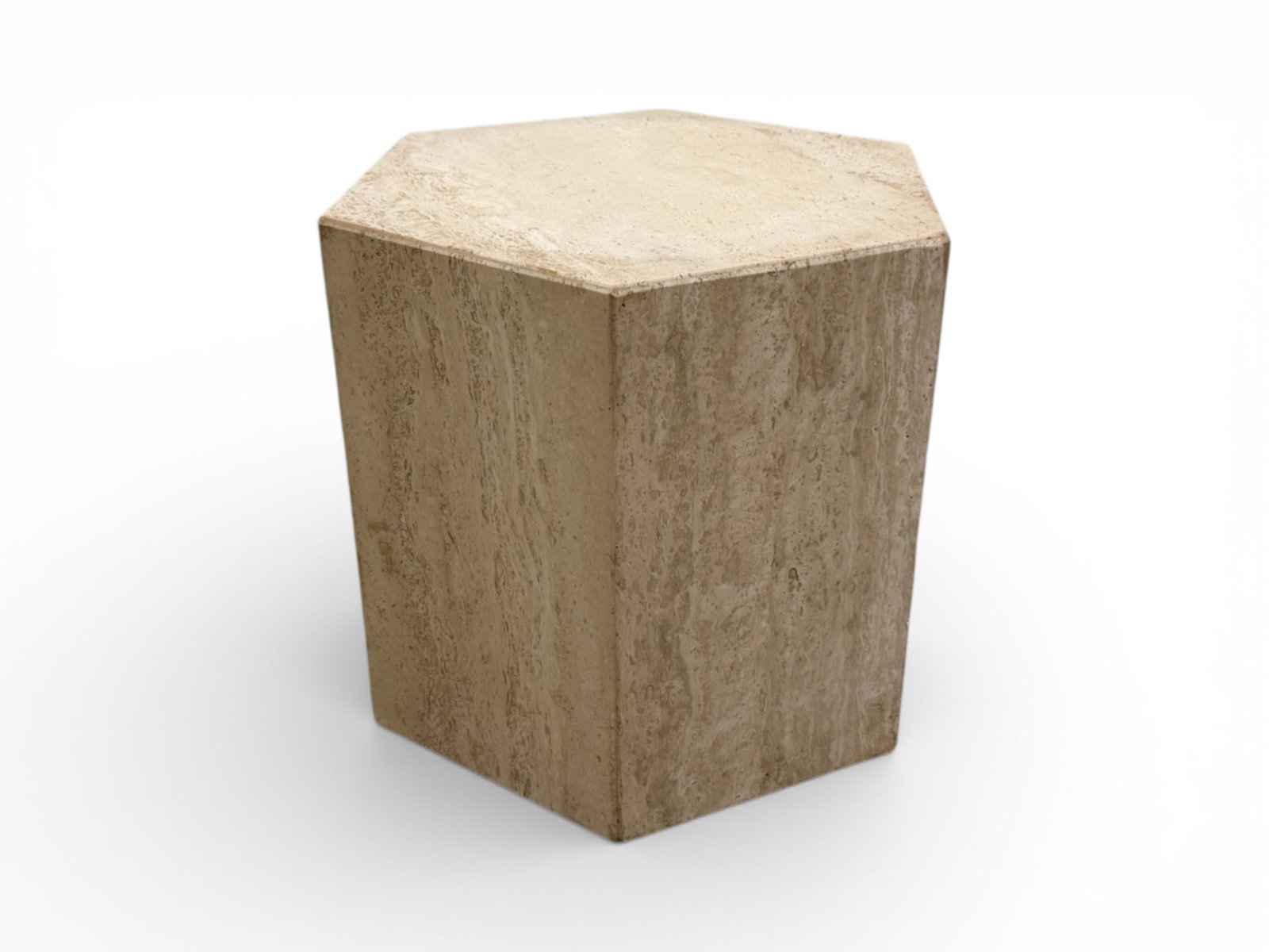 Low Hexagonal Italian Travertine Plinth / Pedestal: A Low Hexagonal Italian Travertine Plinth / Pedestal crafted of a mixture of honed and polished travertine. Circa the 1960s. The frame is hollow and crafted with individual pieces. Natural variations