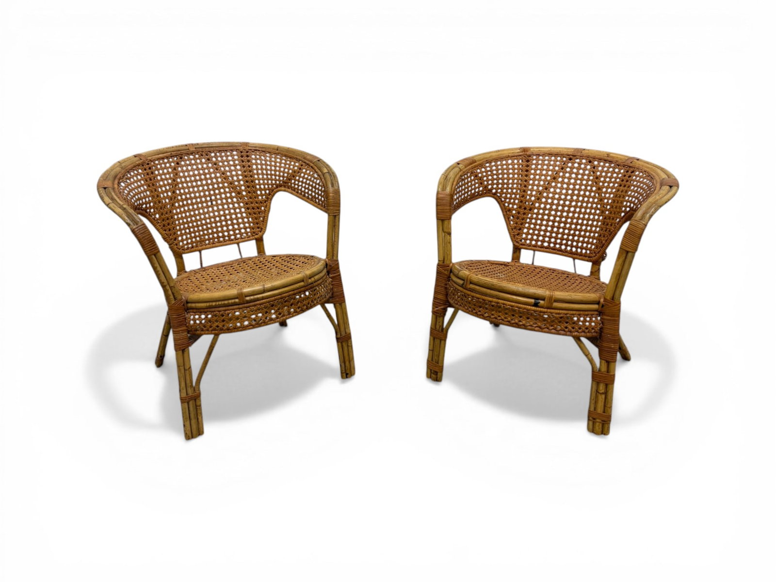 Pair of Rattan & Cane Chairs: Pair of rattan and cane armchairs. Dimensions: H:27.5" W: 25.25" D:24", seat height 17".