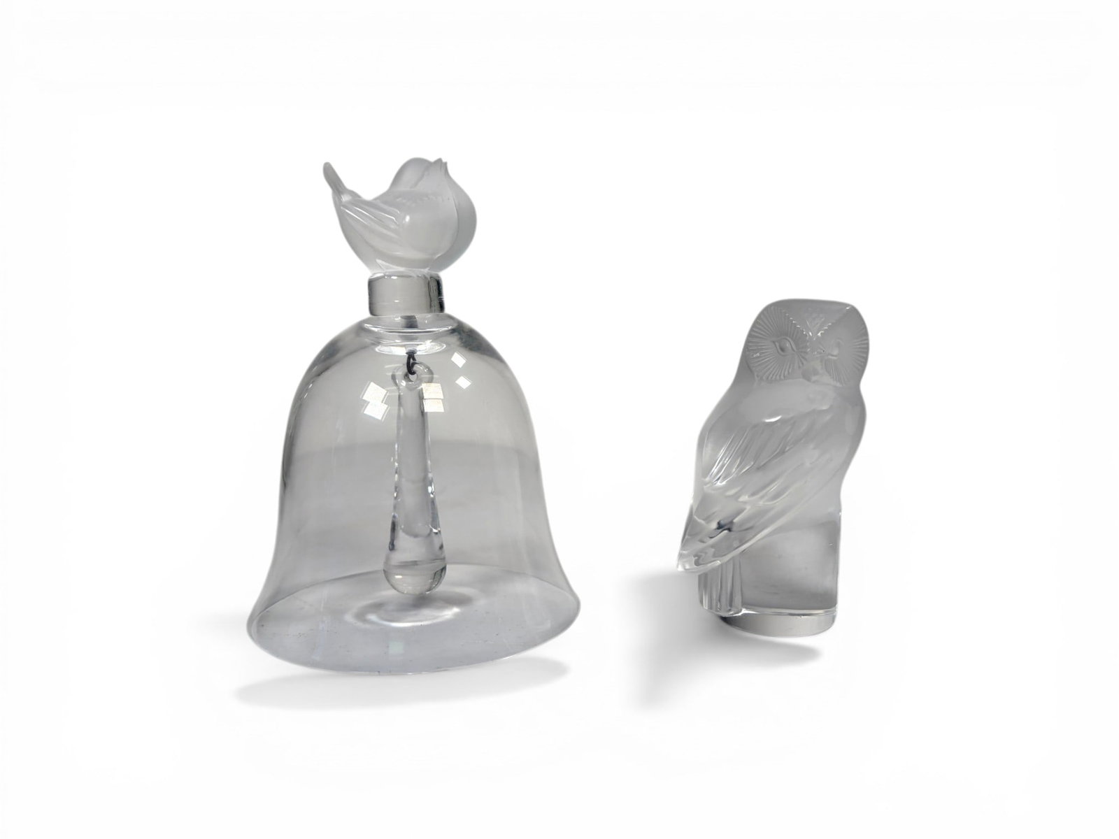 2 Pieces Signed Lalique France Bell & Owl: 2 pieces signed Lalique France crystal. Bird bell, and owl figurine. Both signed Lalique France. Bell dimensions: H: 5.125" W: 3.75" D: 3.75" Owl dimensions: H: 3.5" W: 1.75" D: 1.25"