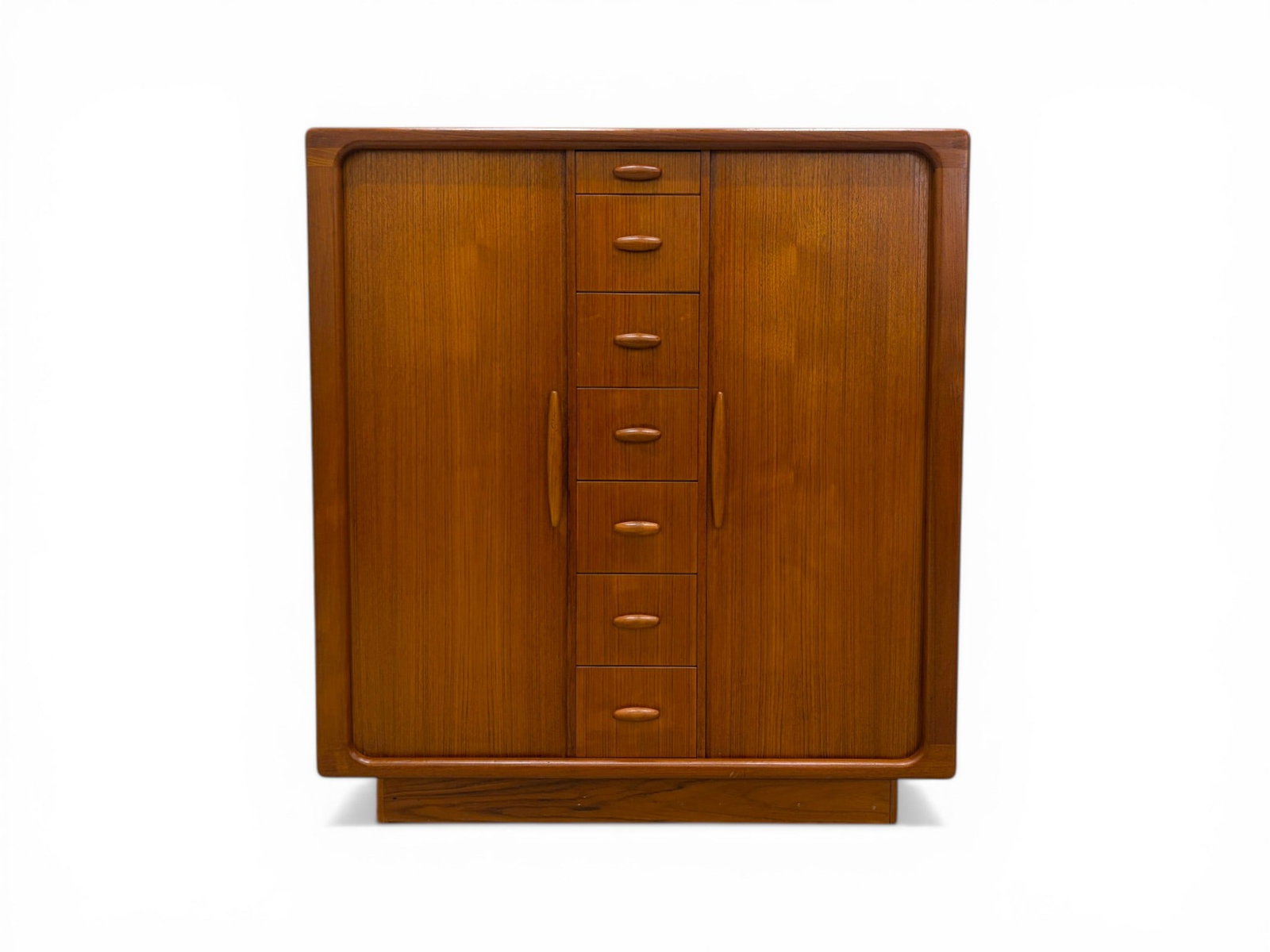 Dyrlund Tambour Door Gentleman's Chest: Dyrlund Danish modern teak gentleman's chest / high chest. 2 tambour doors, interior with shelves and 7 drawers, 7 central drawers. Dyrlund label to interior of top drawer. Dimensions: H: 52.25" W: