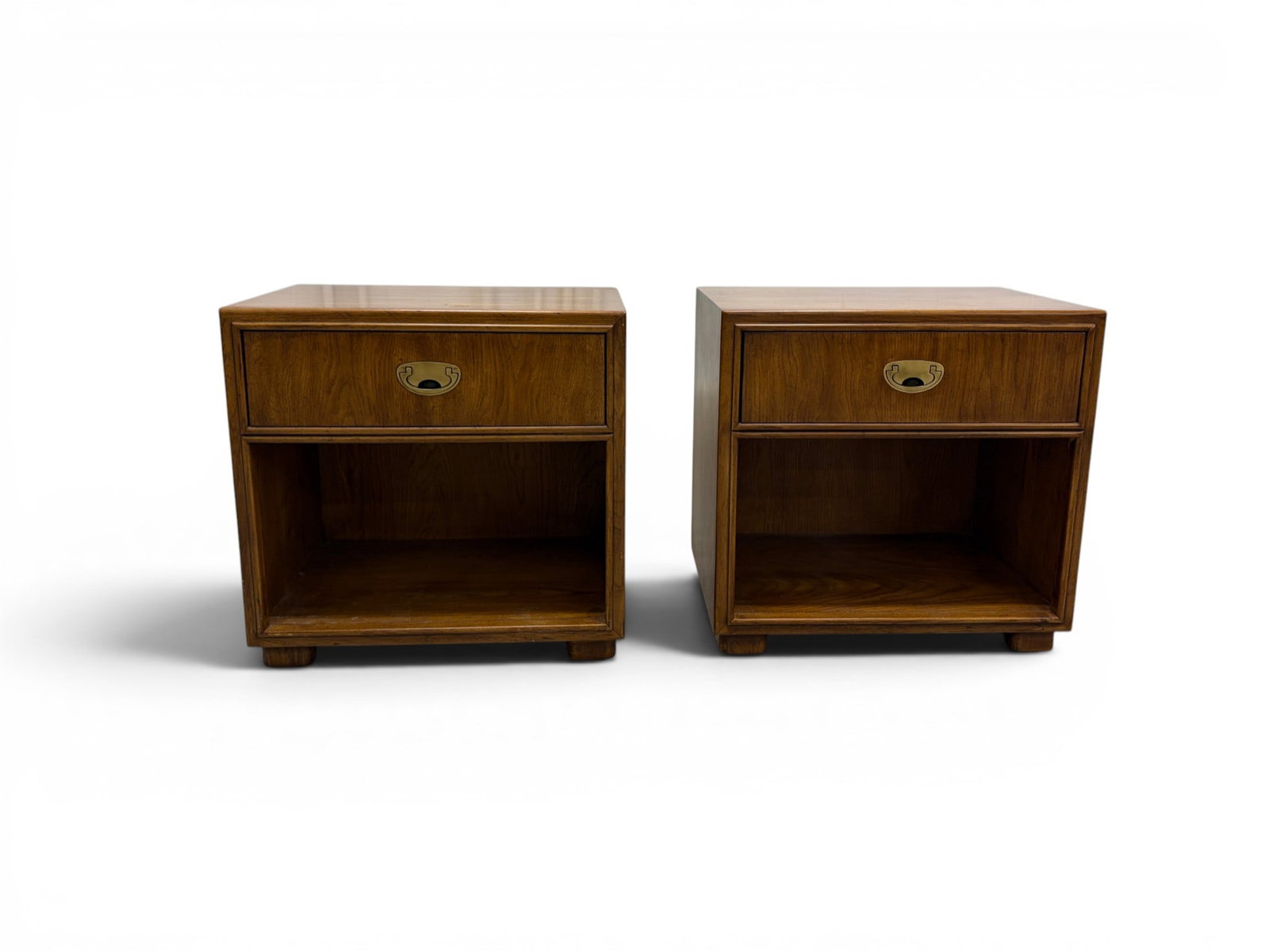 Pair of Drexel Passage Campaign Style Nightstands: Pair of Drexel Heritage "Passage" campaign style nightstands. Walnut with brass pulls. Drexel marks inside top drawers on back panels. Dimensions: H: 24.25" W: 25" D: 17"