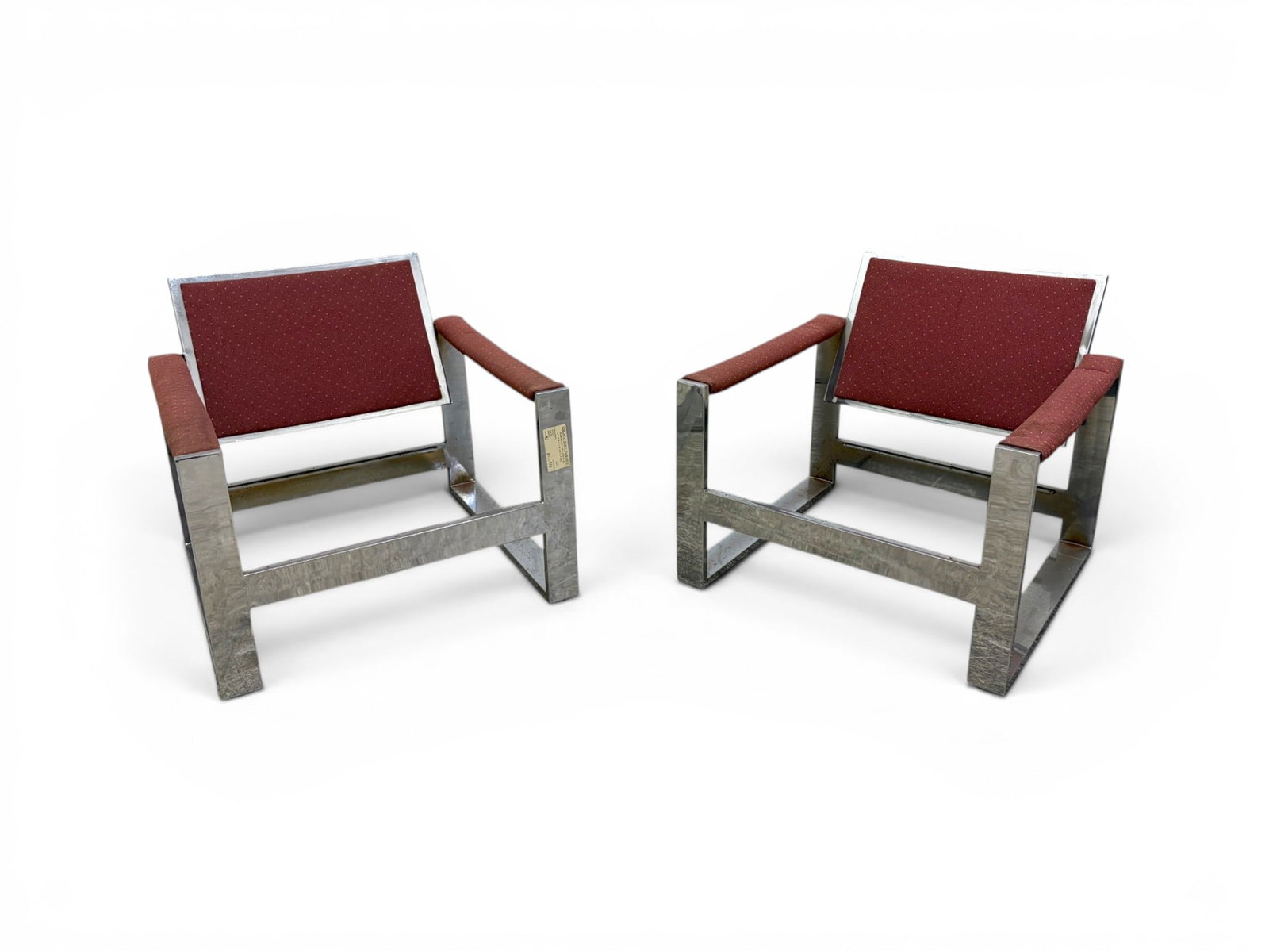 Pair Milo Baughman Tank Armchairs: Pair of Milo Baughman "Tank" armchairs. Chrome and upholstered arms and back. No strapping or cushion for seats. Unmarked. Dimensions: H: 26.75" W: 30.25" D: 32.5"