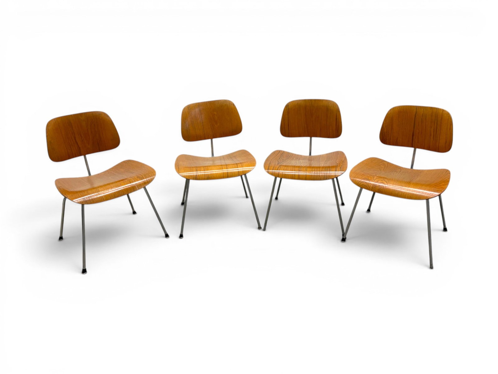 4 Eames for Herman Miller DCM Chairs: Set of 4 Charles & Ray Eames for Herman Miller DCM chairs. Wood seats and backs, chrome frames. 1 chair with "Charles Eames Design, Herman Miller" label to the underside of seat. Dimensions: H: 29.5" 