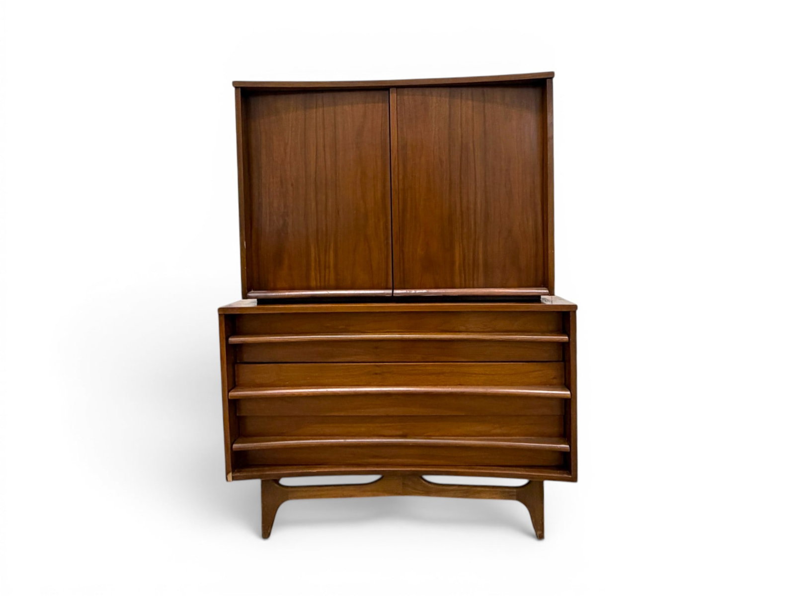 Young Mfg. Concave High Chest: Young Manufacturing concave curved front mid-century modern teak high chest. 2 parts, top cabinet section with 2 doors and interior shelf and 3 drawers. Lower dresser section with 3 drawers. Stamped