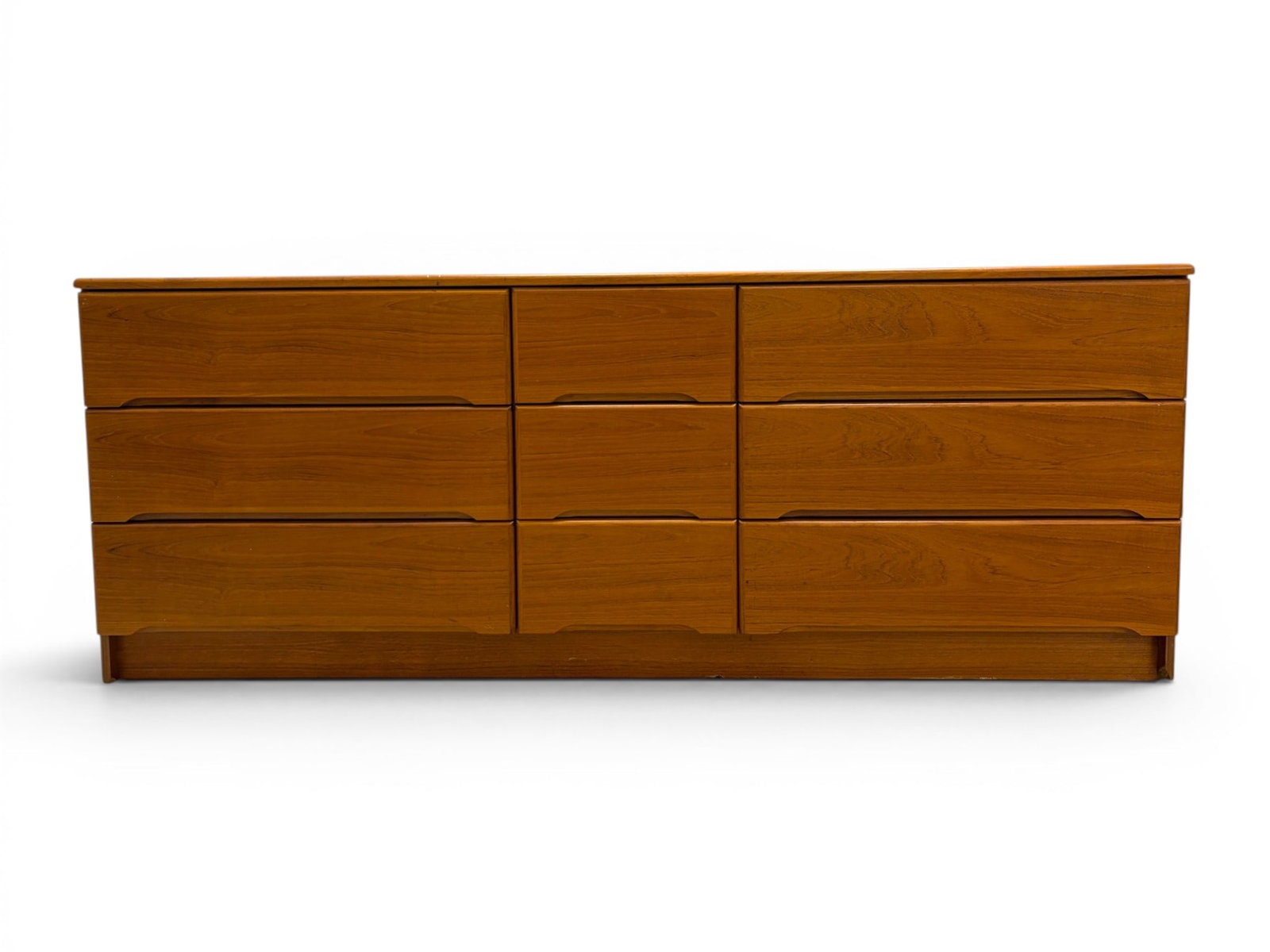 Danish 9 Drawer Dresser: Danish teak veneer 9 drawer dresser. Stamped Made in Denmark. Dimensions: H: 29" W: 74.5" D: 18.25"