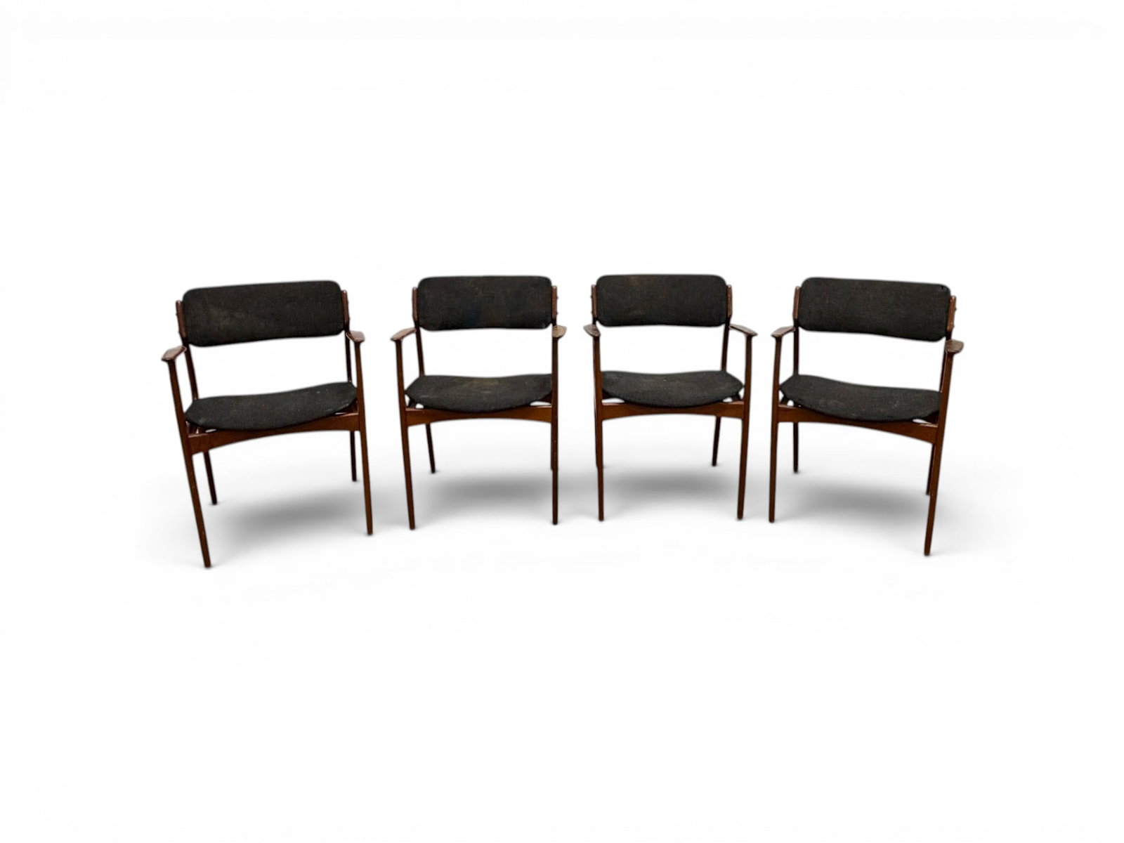 Set of 4 Erik Buck Dining Chairs: Erik Buck (Buch). Set of 4 armchairs. All unmarked, 2 with Hotellers Hvidevareforsyning Kobenhavn labels on the undersides. Dimensions: H: 31.25" W: 32.5" D: 20.25", seat height 18.5"
