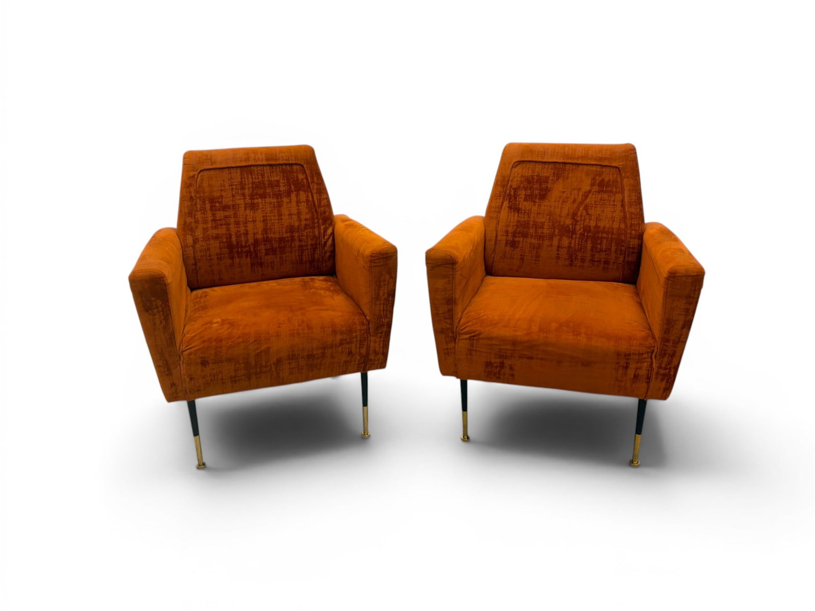 Pair of Mid-Century Modern Style Lounge Chairs: Pair of mid-century style lounge chairs, with orange upholstery and metal legs. Dimensions: H: 35.5" W: 29.75" D: 31"
