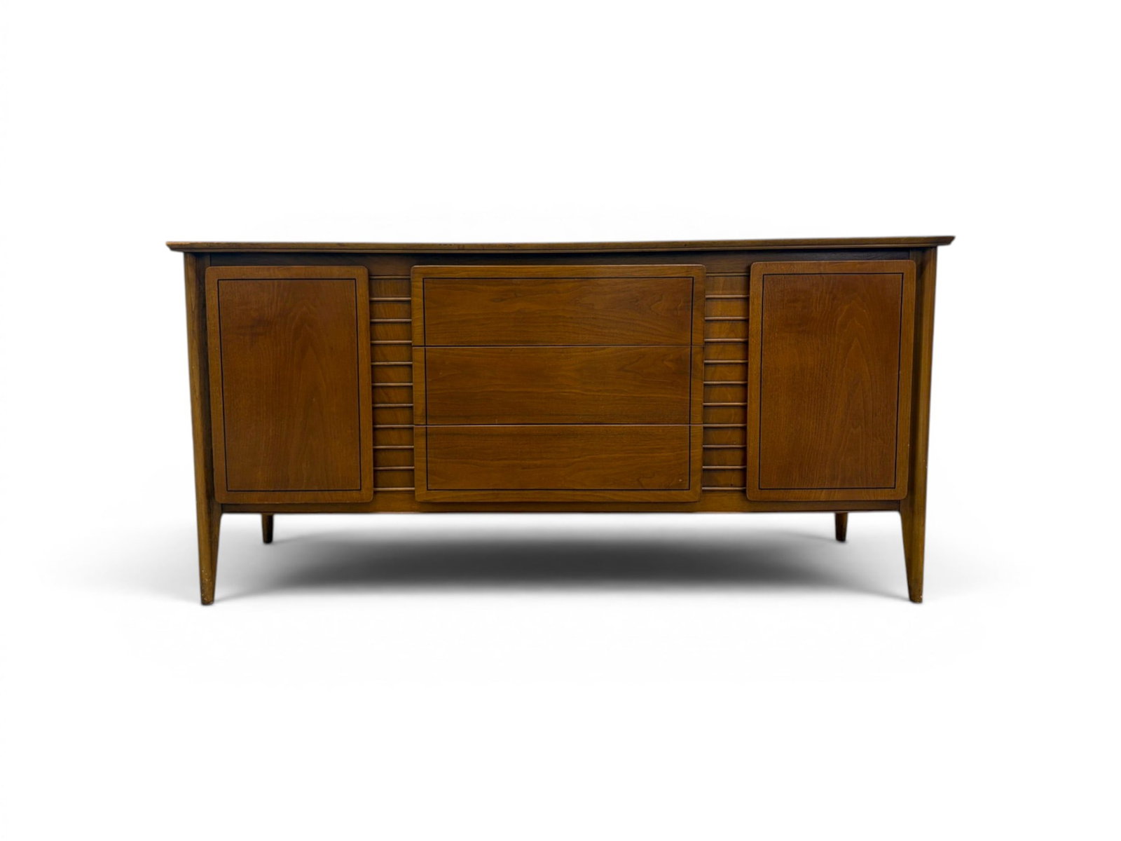 Mid-Century Modern Sideboard: Modern sideboard. 2 cabinet doors with interior shelves, 3 central drawers. Dimensions: H: 30" W: 62" D: 19"