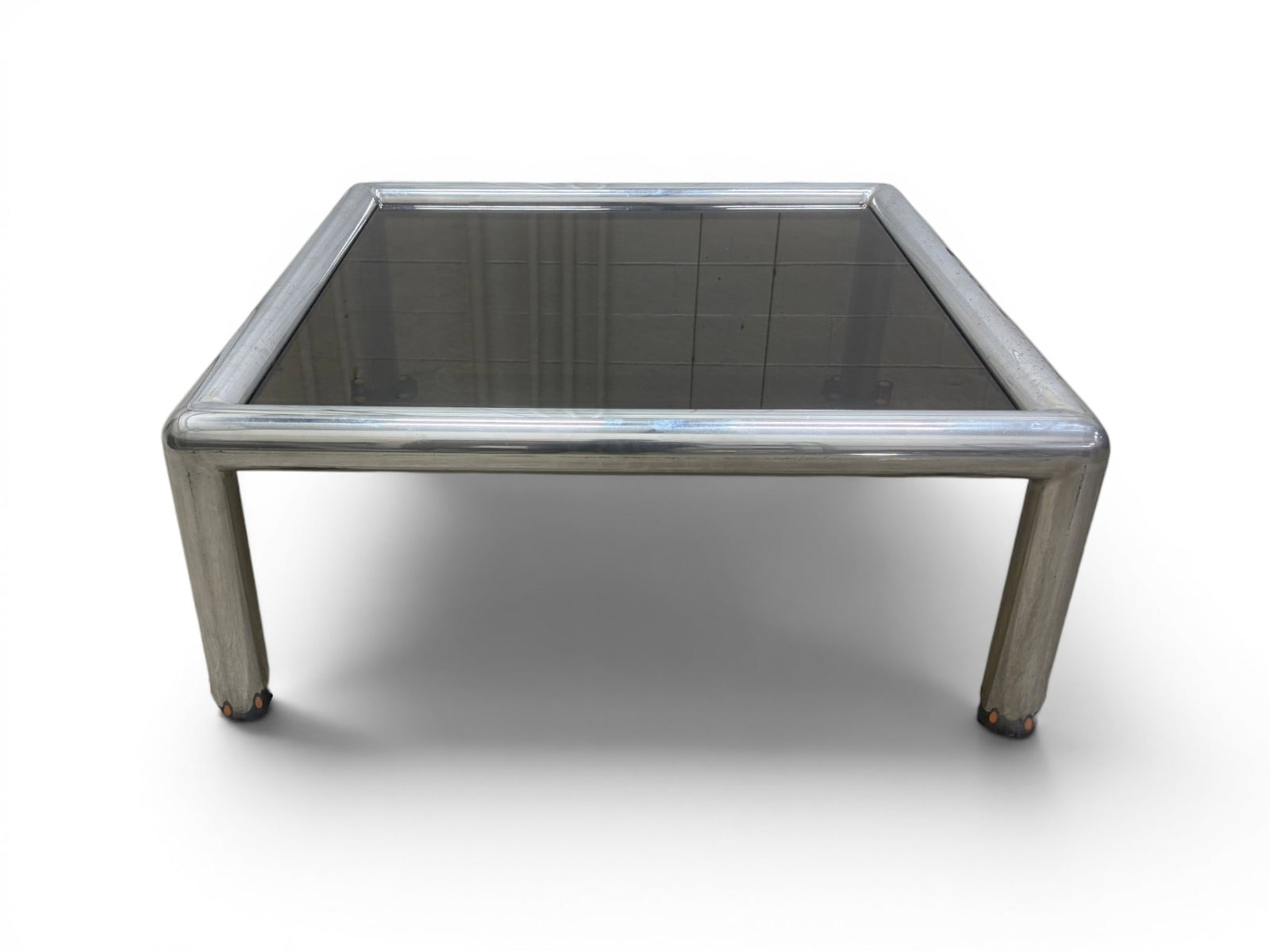 John Mascheroni Aluminum & Glass Tubo Coffee Table: John Mascheroni aluminum and smoke glass Tubo coffee table. Dimensions: H: 17" W: 41.5" D: 41.5".