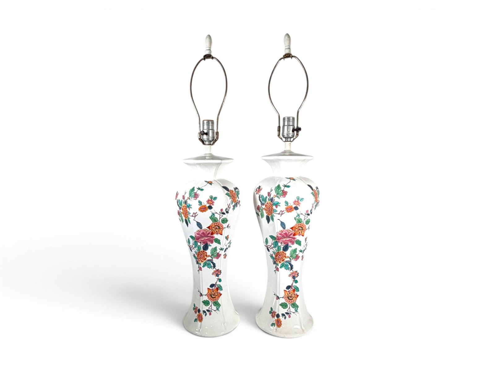 Pair of Chinese Style Porcelain Table Lamps: Pair of Chinese style porcelain table lamps, with hand painted floral decoration. Dimensions to tops of finials: H: 31.25" W: 7.5" D: 7.5"