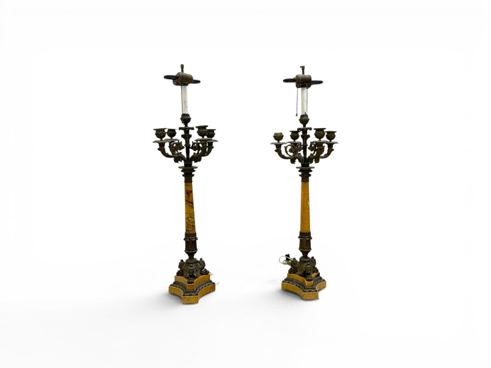 Pair of Bronze & Marble Candelabra Lamps: Pair of bronze and marble candelabra lamps. Bronze with 4 candelabra lights and 2 electrified lights, paw feet, marble columns and bases. Dimensions without shades: H: 33.75" W: 10.5" D: 10.5".