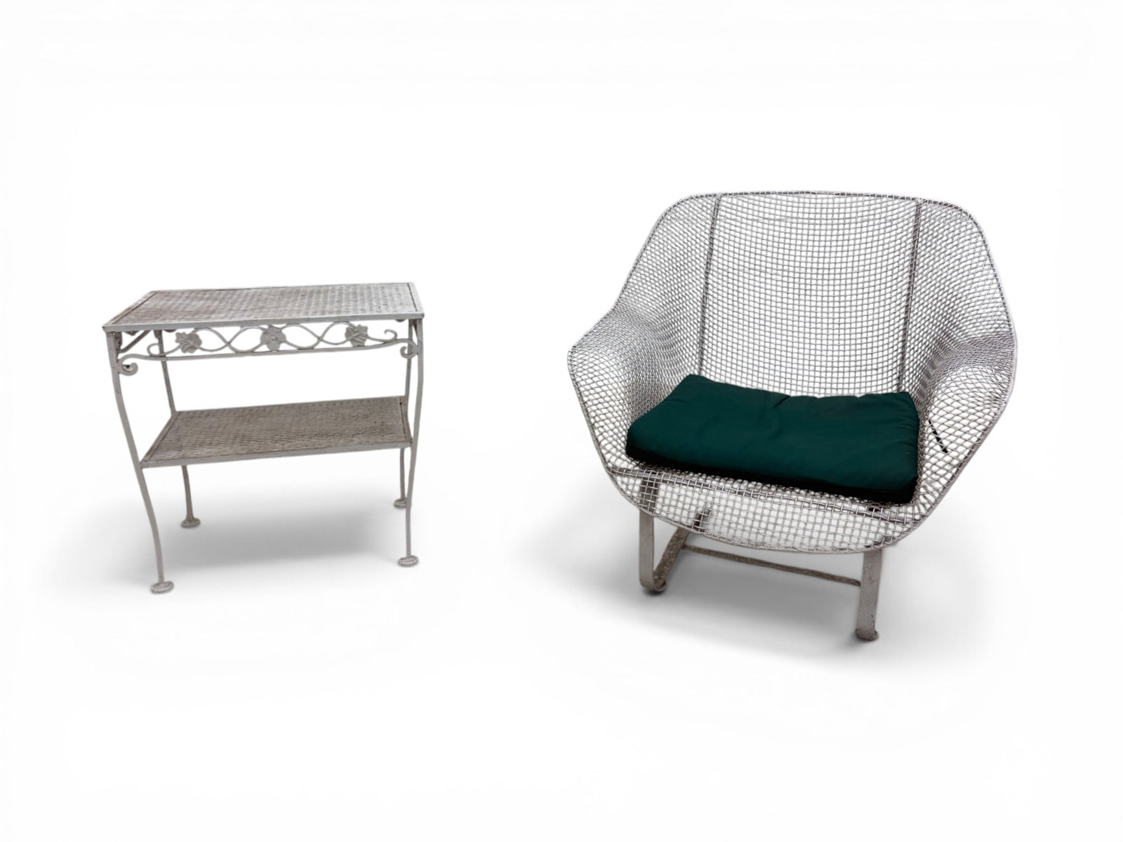 Woodard Sculptura Chair With Side Table: Woodard wrought iron and wire Sculptura spring lounge chair with a wrought iron outdoor side table with floral motif. Both unmarked. Chair dimensions: H: 33.5" W: 32.125" D: 29", seat height 12.875"