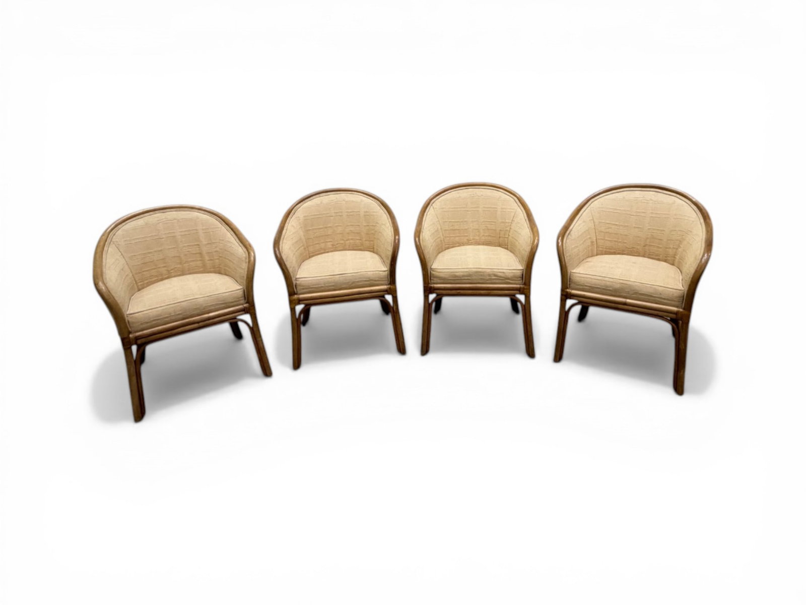 4 Ficks Reed Rattan Dining Chairs: Set of 4 Ficks Reed upholstered rattan armchairs. Ficks Reed labels on the undersides. Dimensions: H: 32" W: 25" D: 24.25", seat height 19"