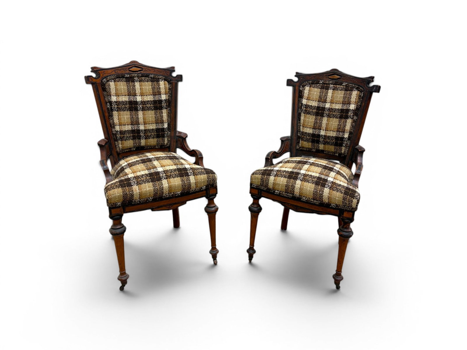 Pair of Victorian Parlor Chairs: Pair of Victorian parlor chairs. Carved, with plaid upholstery, front legs on casters. Dimensions: H: 34" W: 18" D: 21.25", seat height 18.75"