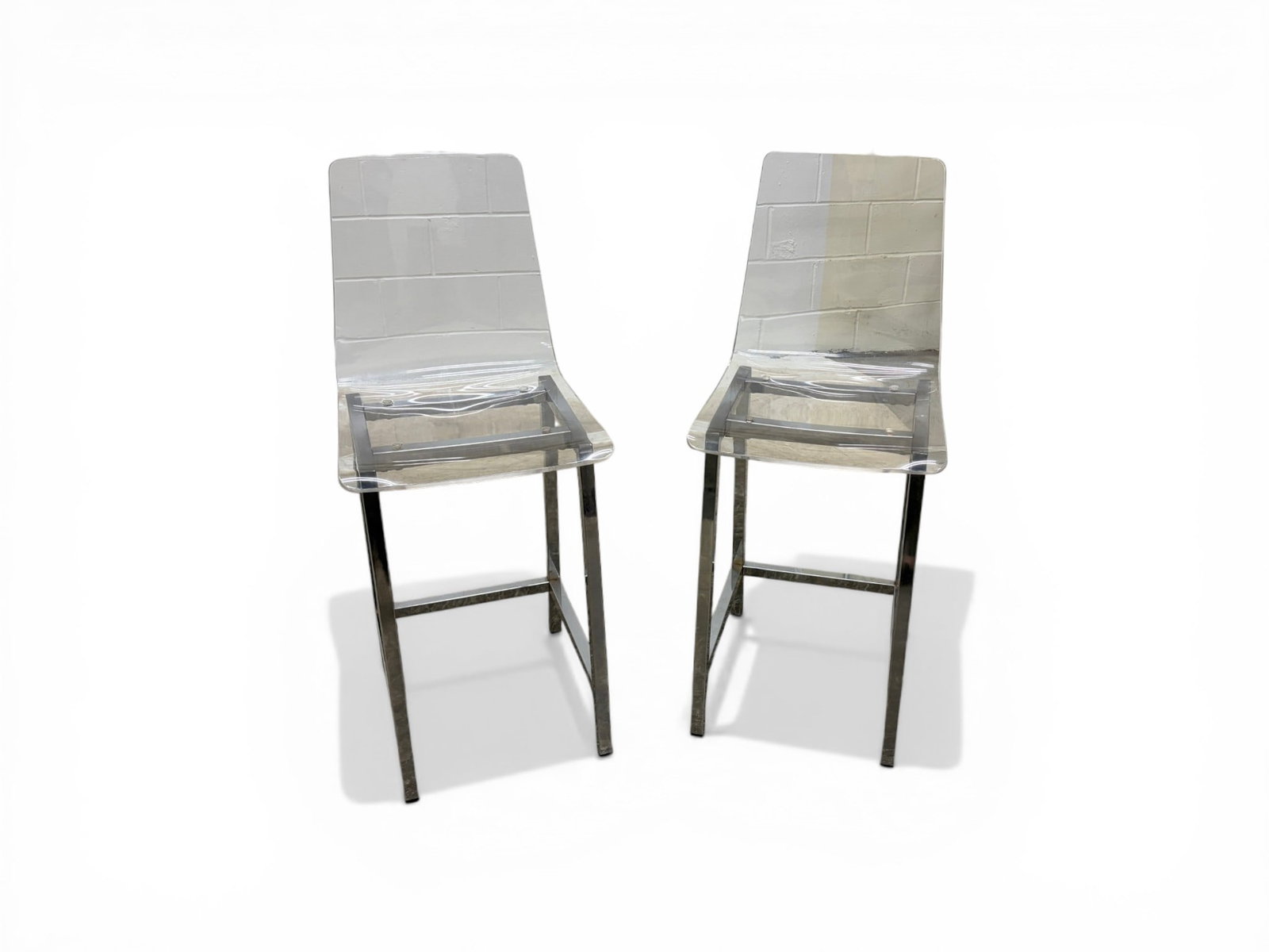 Pair Chrome & Lucite Counter Stools: Pair of chrome and lucite counter chairs. Dimensions: H: 39.5" W: 17.125" D: 15.5", seat height 23.25