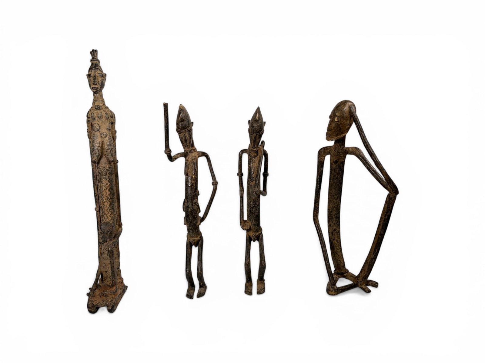 4 African Bronze Sculptures Dogon, Senufo: 4 African bronze sculptures, including Dogon and Senufo. Dimensions: H: 18.5" W: 2" D: 5.5" Dimensions: H: 14.75" W: 3.5" D: 2.25" Dimensions: H: 14.25" W: 1.5" D: 2.75" Dimensions: H: 14.5" W: 4.5"