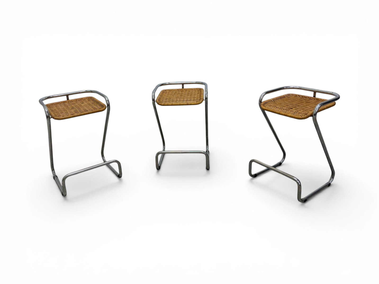 3 Italian Chrome & Wicker Counter Stools: Set of 3 chrome and wicker Z form counter stools. "Made in Italy" labels on the undersides Dimensions: H: 28.5" W: 18.75" D: 18.25", seat height 25".