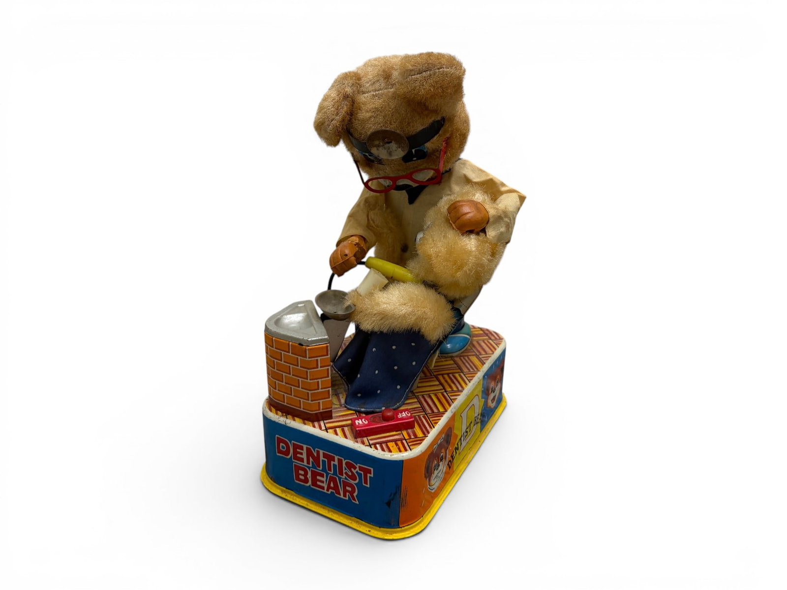 Tin Litho Dentist Bear Battery Operated Toy: Tin litho Dentist Bear battery operated toy. Dimensions: H: 9" W: 6.75" D: 4.25"
