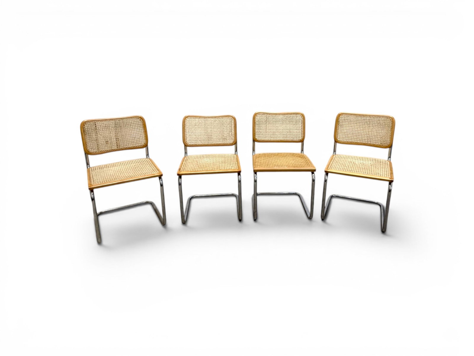 4 Marcel Breuer Style Cesca Chairs: Set of 4 Marcel Breuer style Cesca chairs. Chrome frames, cane seats. Unmarked. Dimensions: H: 31.5" W: 18.25" D: 21"