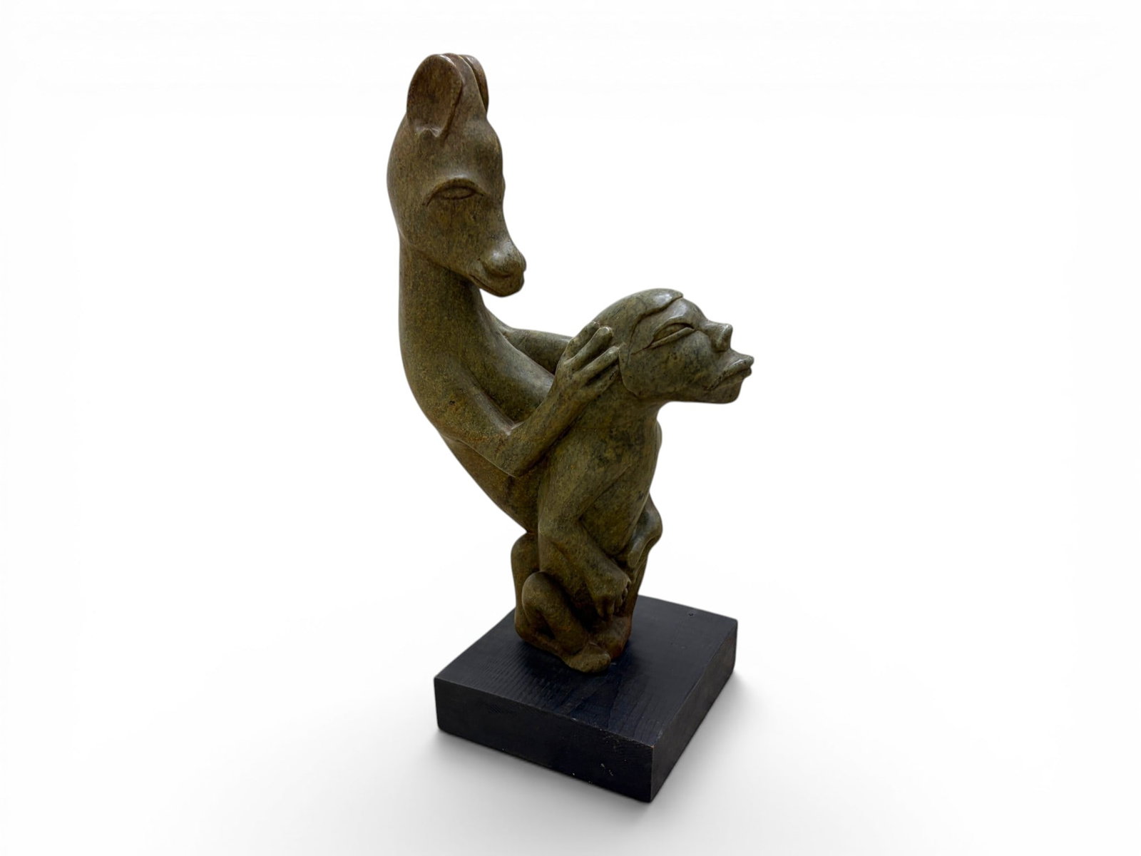 Carved Stone Sculpture Two Figures: Carved stone sculpture of two figures. Unsigned. On painted wooden base. Dimensions: H:24" W:9" D:9"