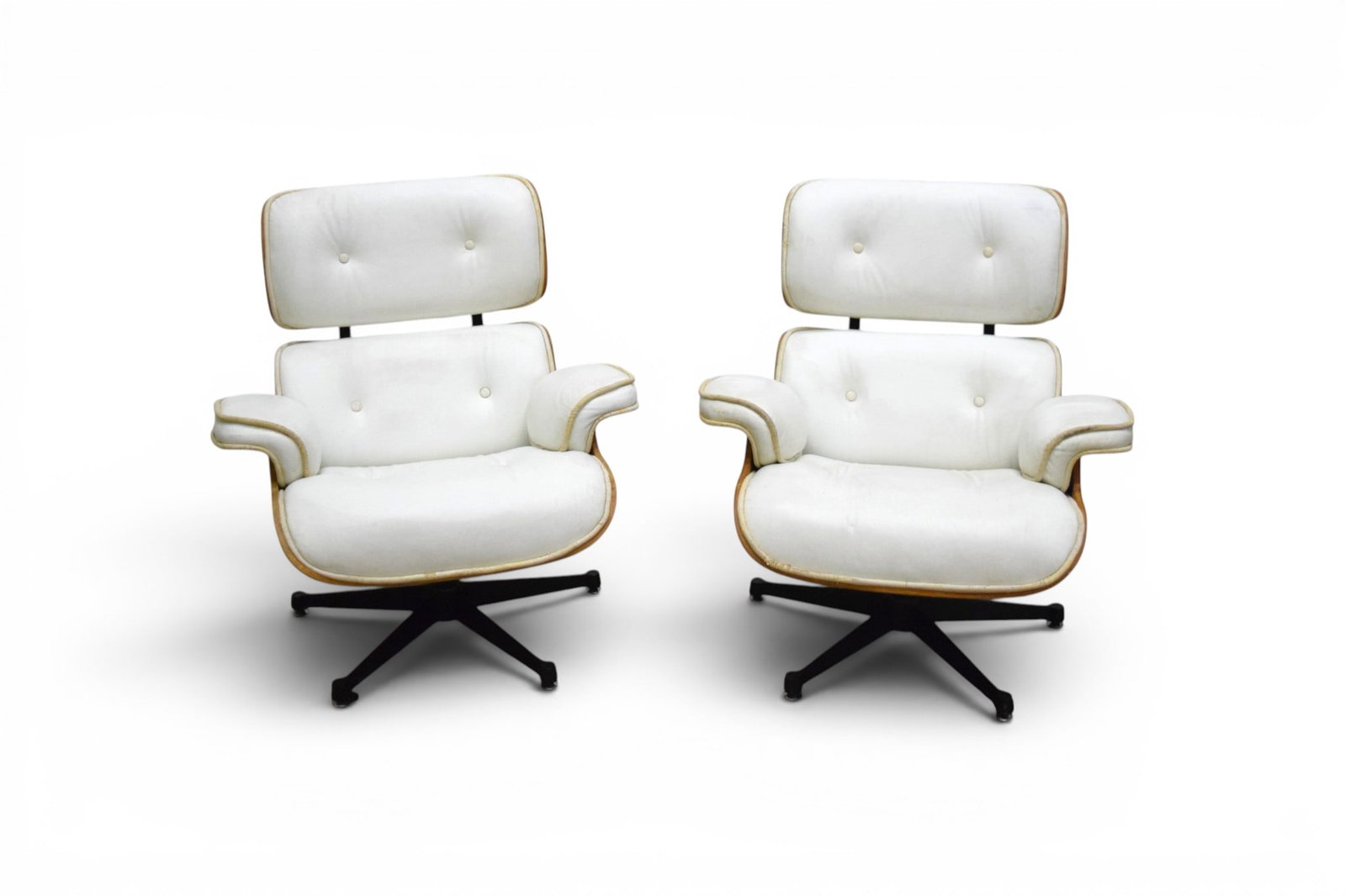 Pair Eames Style Lounge Chairs: Pair of Eames style lounge chairs with white leather upholstery. Both unmarked. Dimensions: H: 33.5" W: 32.5" D: 34", seat height 16"