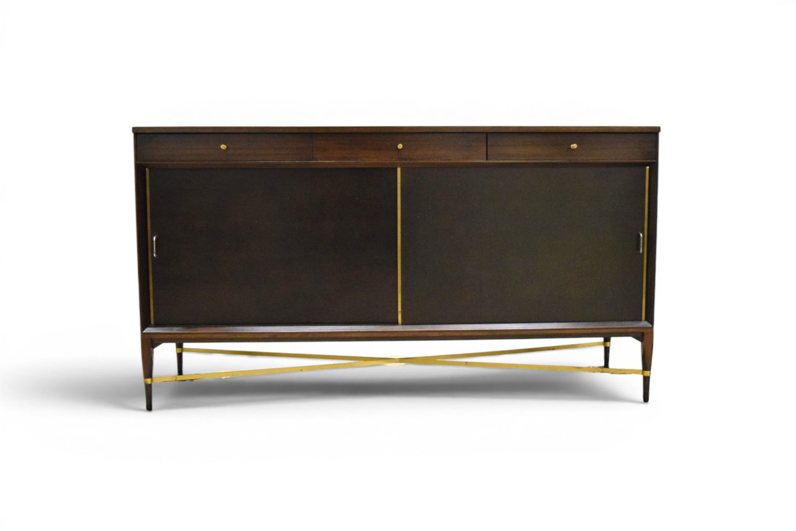 Paul McCobb for Calvin Credenza: Paul McCobb for the Calvin Group, mid-century modern credenza. 3 drawers and 2 sliding leather doors with interior shelves. McCobb Calvin label to interior of center drawer. Dimensions: H: 36" W: 66"