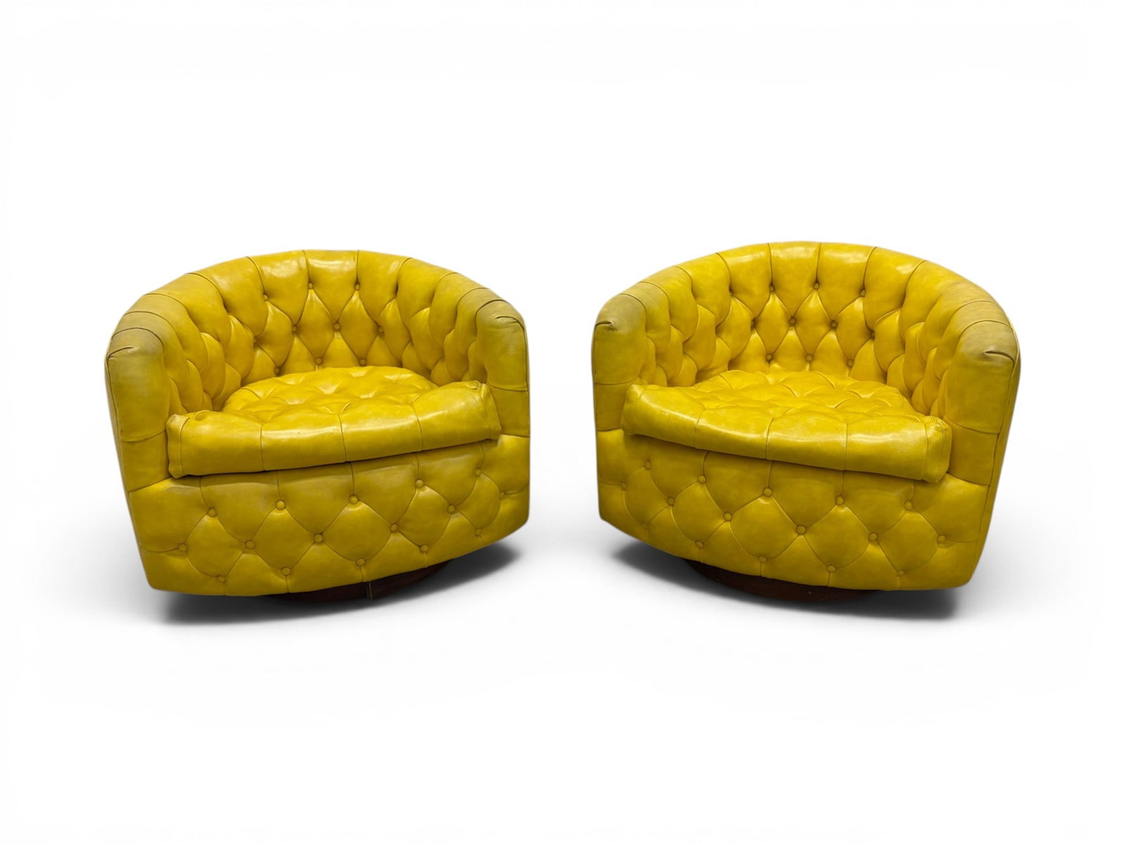 Pair Milo Baughman for Thayer Coggin Lounge Chairs: Pair of Milo Baughman for Thayer Coggin swivel tilt lounge chairs. Tufted yellow leather, Designs By Milo Baughman, Thayer Coggin Institutional Inc. labels on the seats. Dimensions: H: 24.5" W: 30.5" 