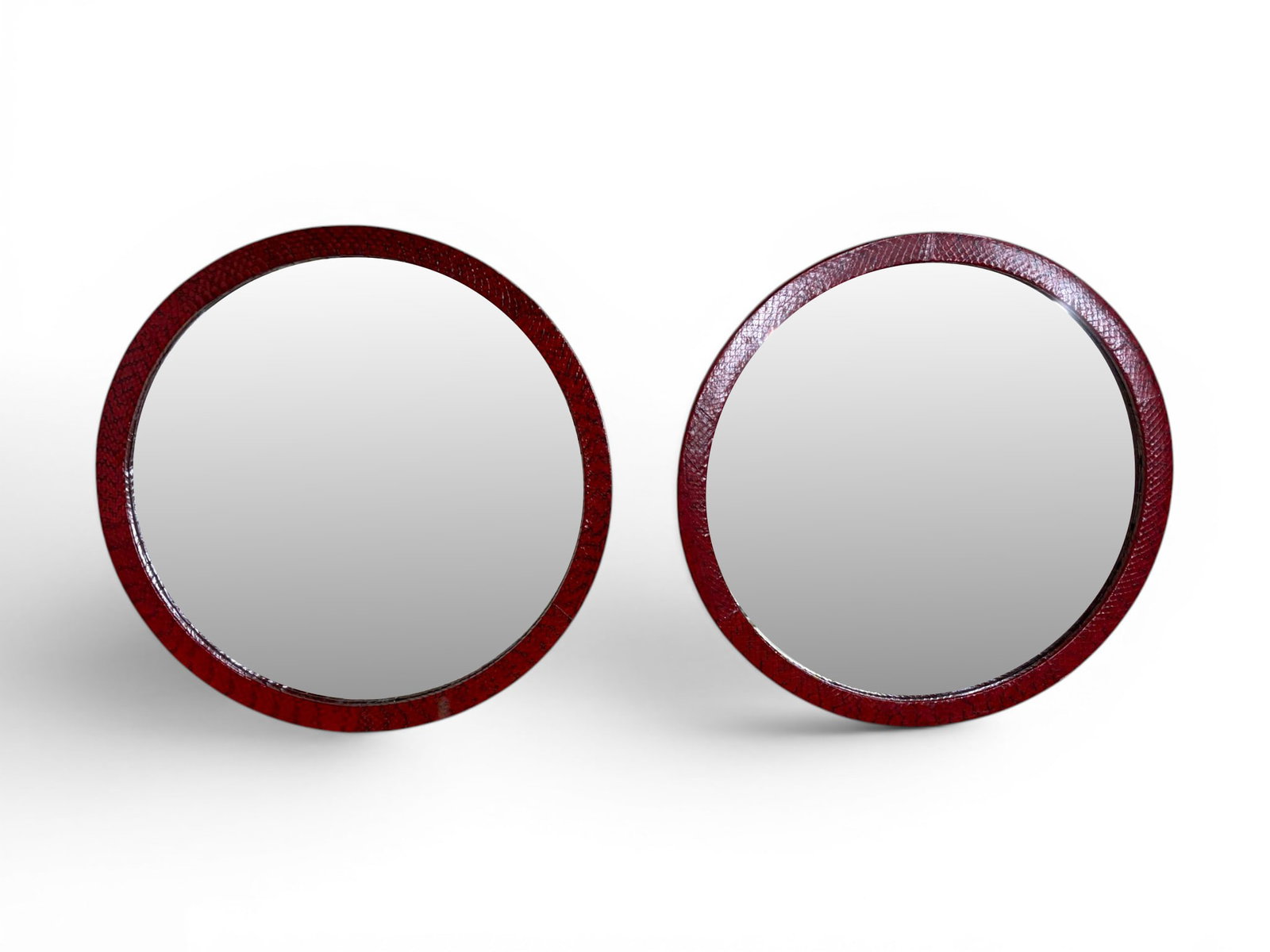 Pair Karl Springer Style Cobra Skin Mirrors: Pair of Karl Springer style snakeskin mirrors. Round mirrors, wrapped in red cobra skin. Dimensions: H: 18.25" W: 18.25" D: .75"