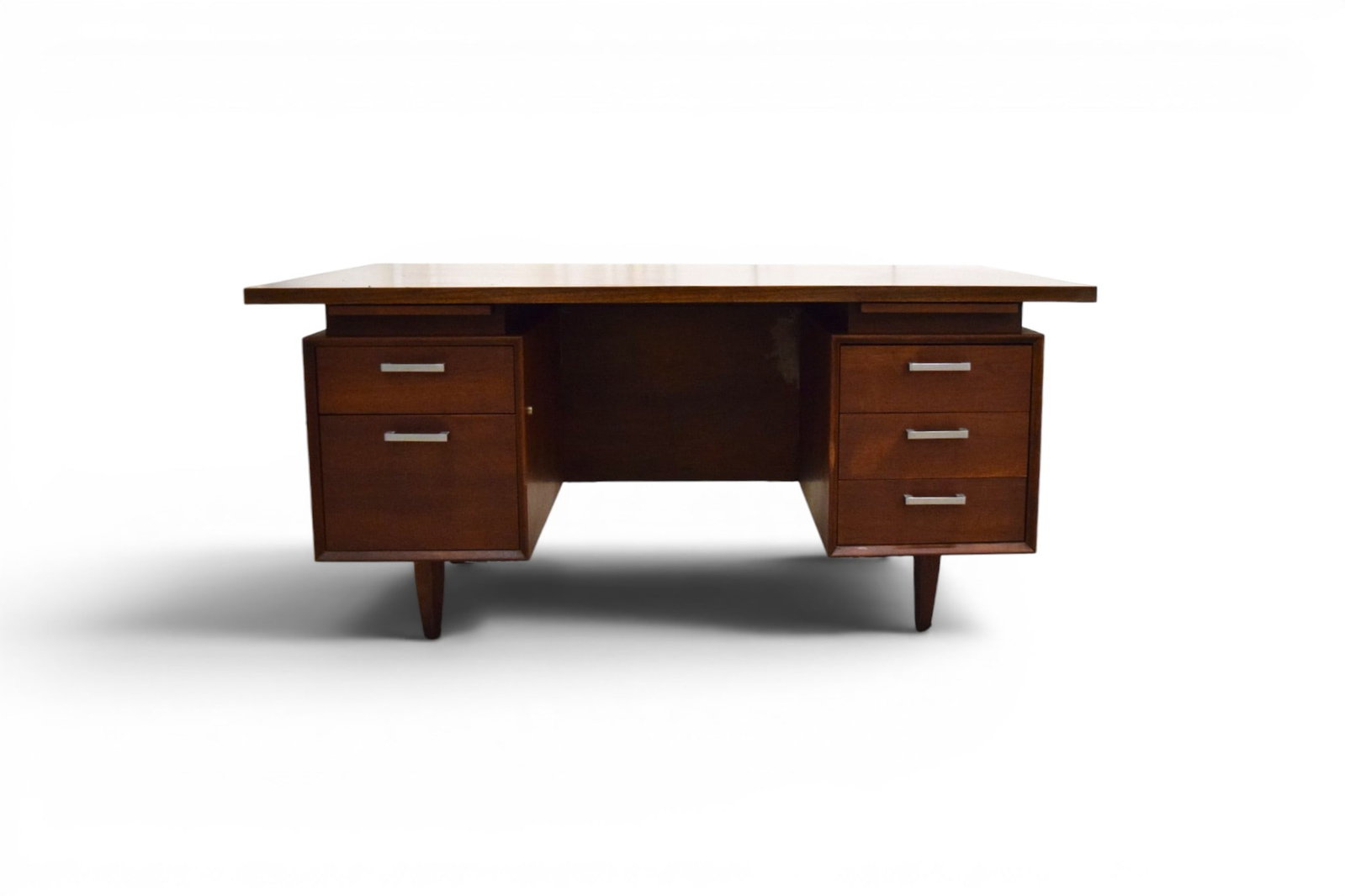 Jens Risom Style Mid-Century Desk: Mid-century modern desk in the style of Jens Risom. Floating top, 2 pull out writing tablets, 5 drawers. With laminate top and woven front. Unmarked. Dimensions: H: 14.5" W: 8" D: 7"
