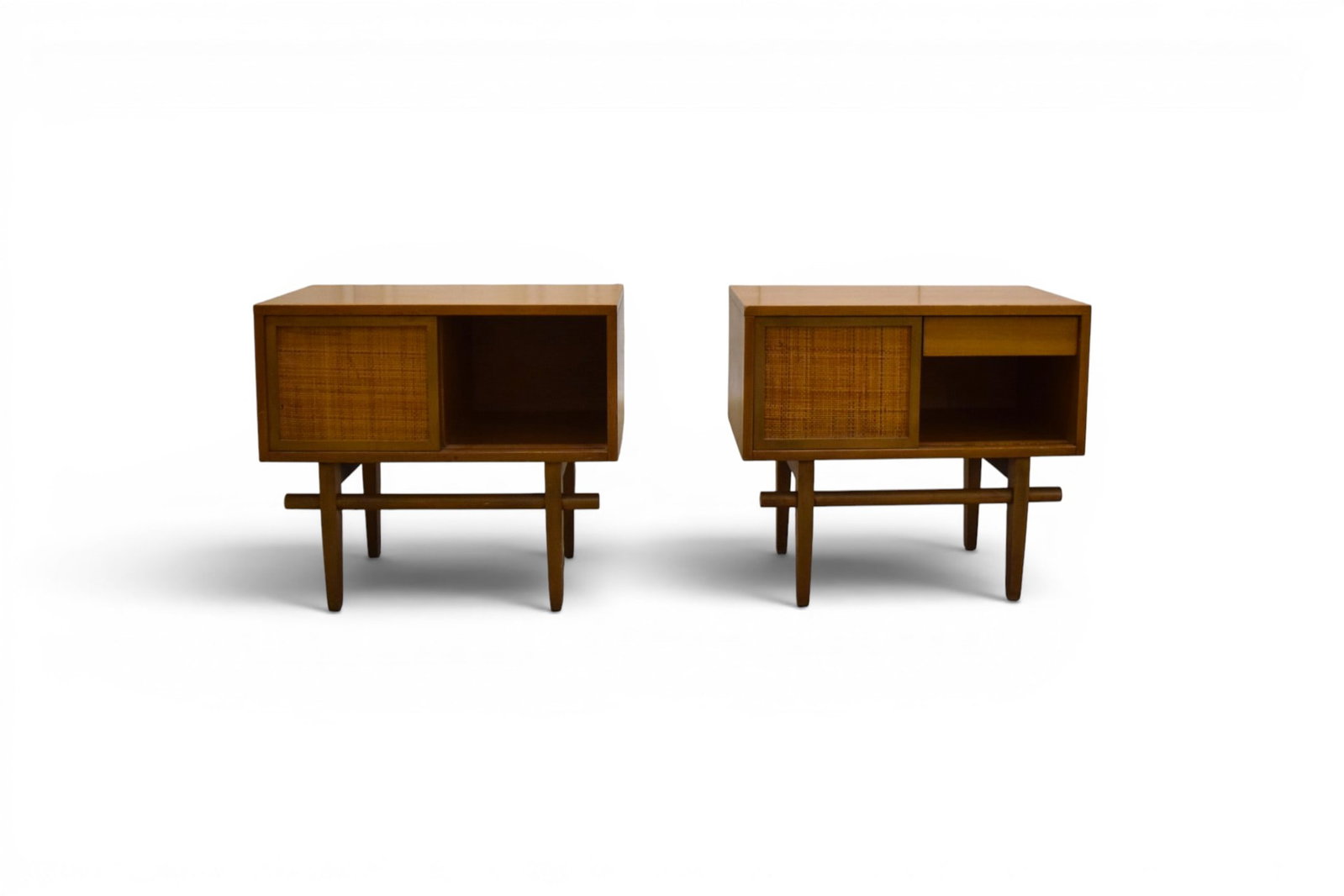 Pair Cane Front Nightstands: Pair of mid-century modern nightstands. Sliding doors with cane fronts and interior drawers. Unmarked. Dimensions: H: 23.25" W: 26" D: 15"