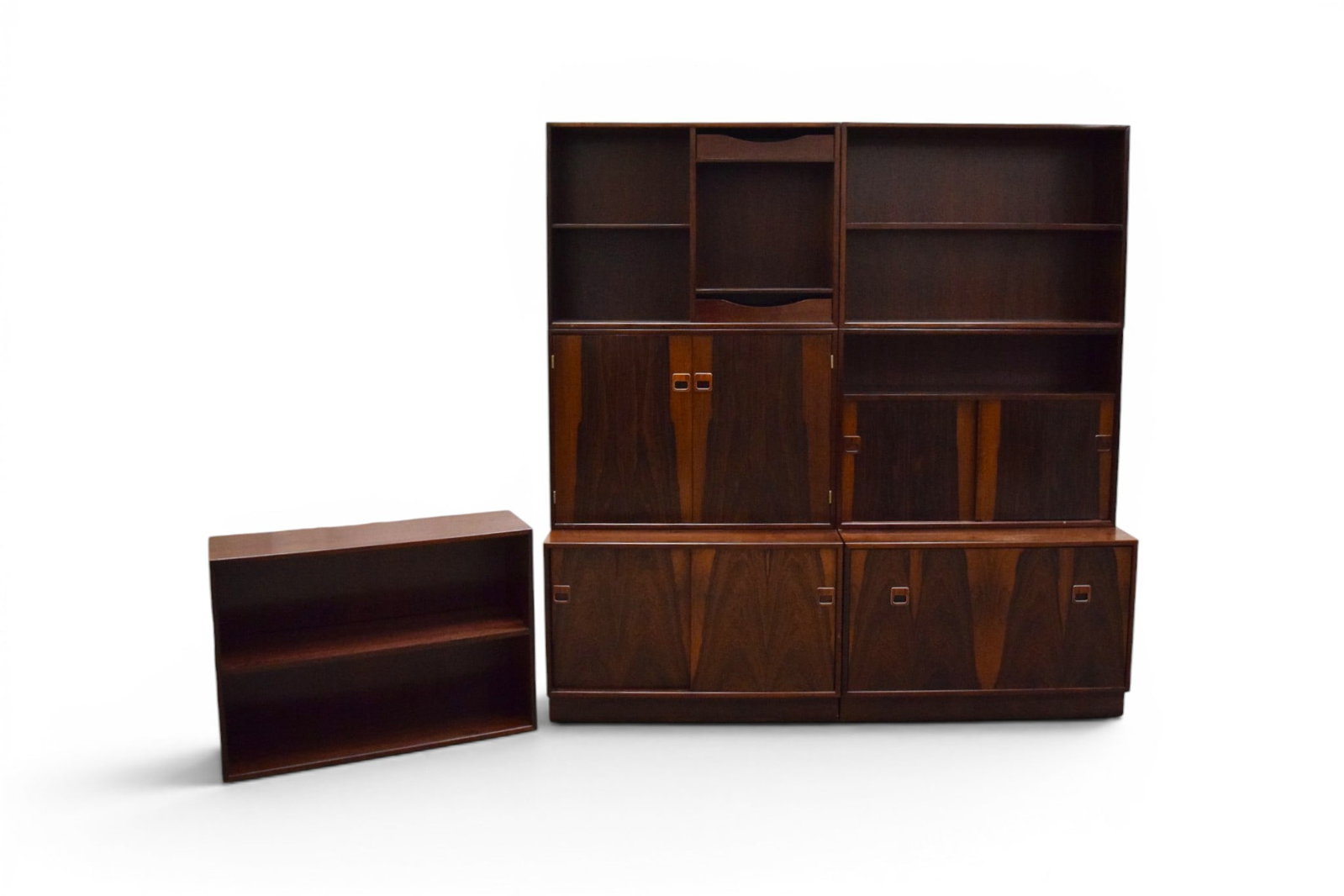 7 Piece Hjornebo Modular Cabinet System: Hjornebo System, modular cabinet. 7 sections, rosewood, all with Hjornebo System, Made in Denmark paper labels. Includes: 2 base cabinets, 1 with drawer and 1 with sliding doors; and upper sections in