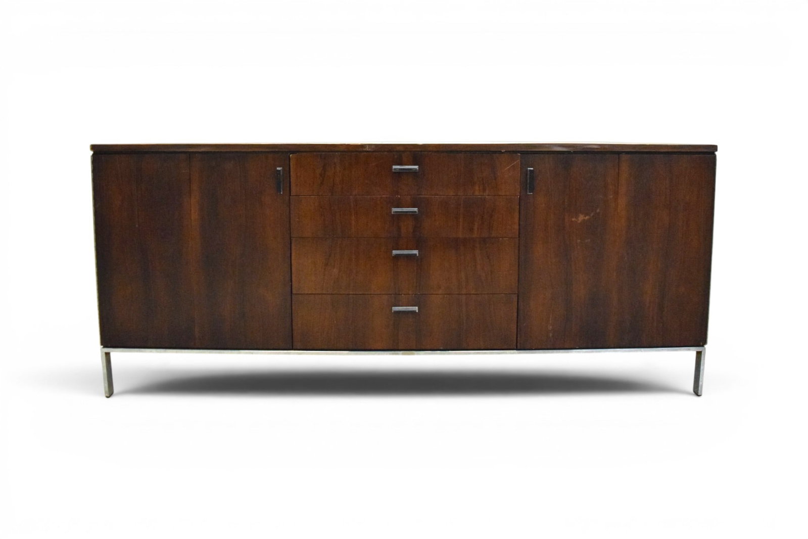Jack Cartwright for Founders Rosewood Credenza: Jack Cartwright for Founders, mid-century rosewood credenza on chrome base. 4 central drawers, with 2 folding doors, one side with interior shelves, one side with 4 interior drawers. Unmarked. Dimensi