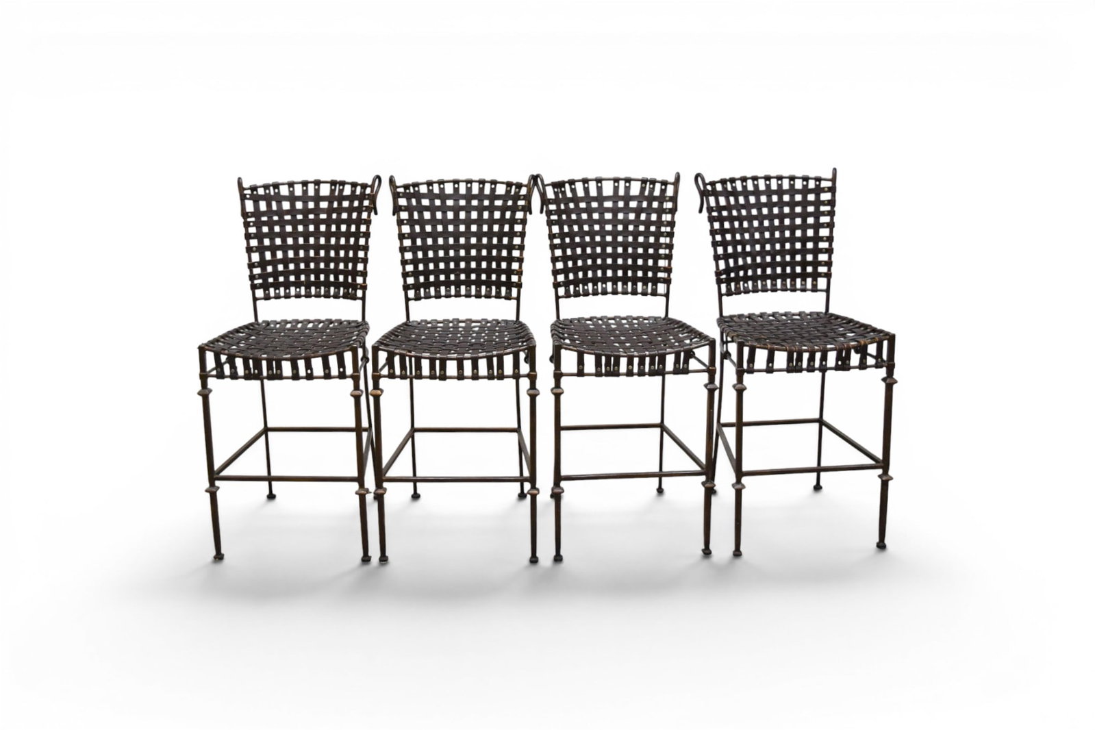 4 Iron & Leather Counter Stools: Set of 4 counter stools. Iron, with woven leather seats and backs. Unmarked. Dimensions: H: 40.5" W: 17.25" D: 21", seat height 24.5"