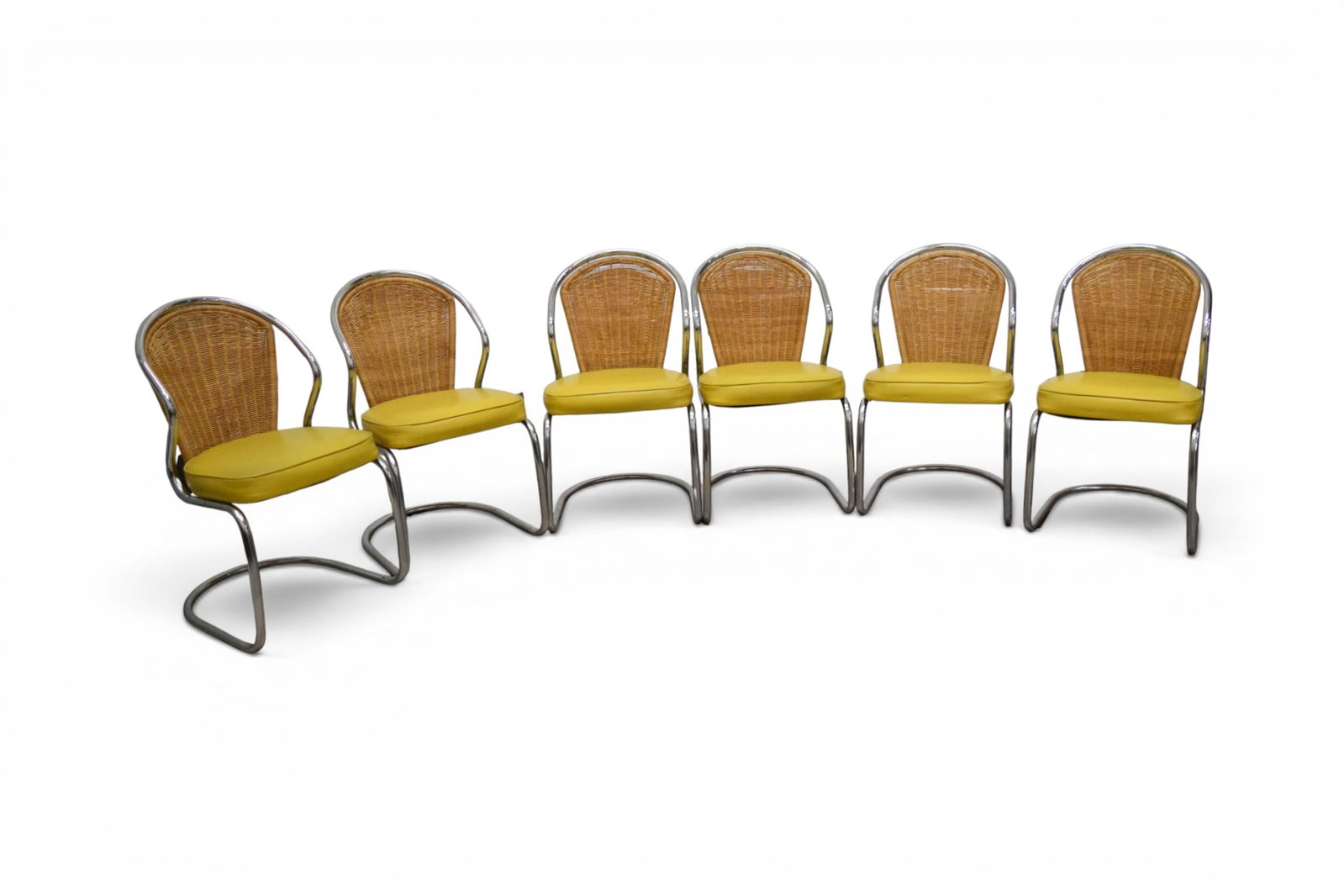 6 Wicker & Chrome Dining Chairs: Set of 6 mid-century chrome dining chairs with wicker backs and yellow vinyl seats. Unmarked. Dimensions: H: 33.5" W: 19" D: 24", seat height 19"