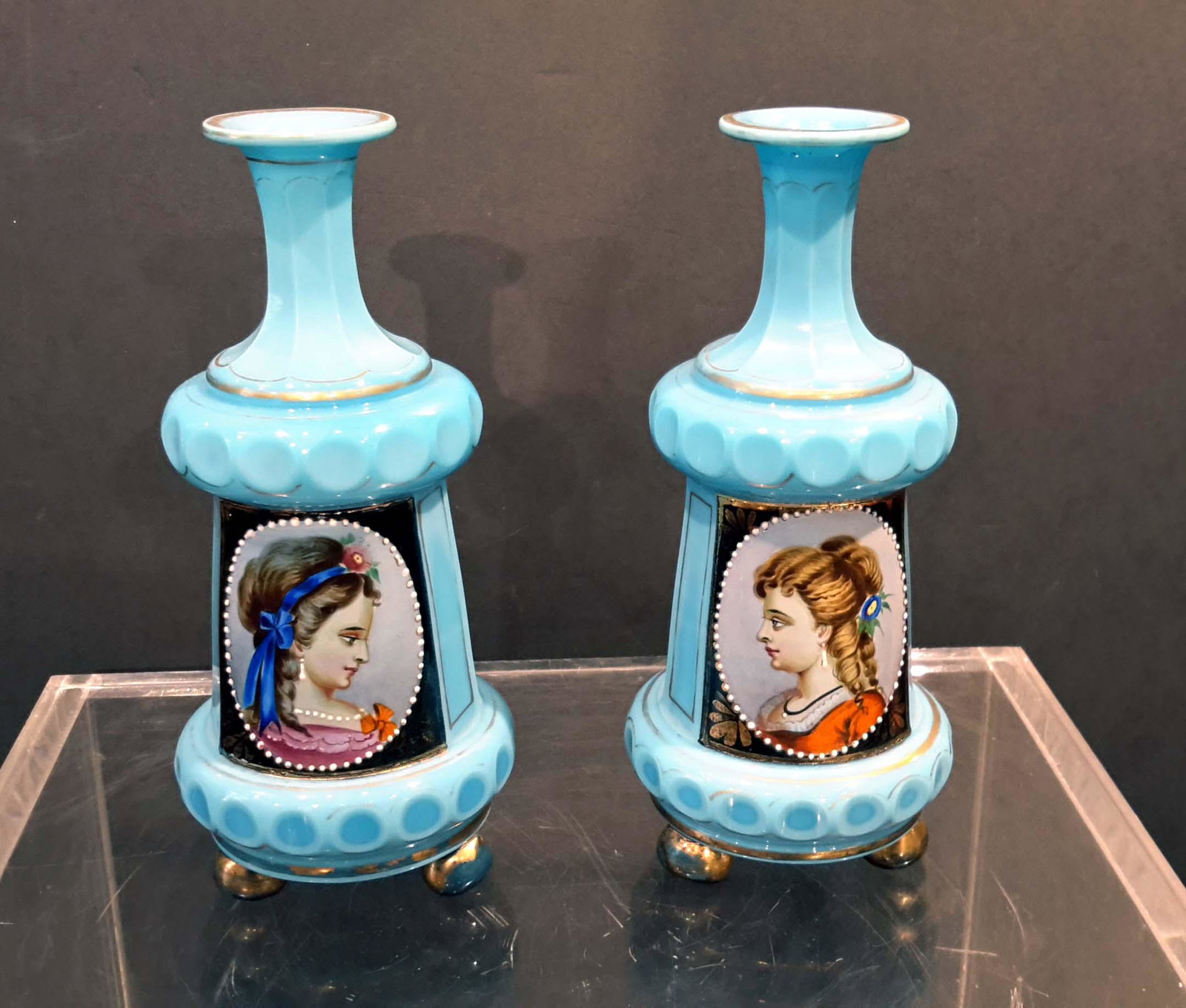 Pair of Bohemian Perfume bottles: Blue opaline milk glass and hand painted portraits of two young beauties. Germanu, Circa 1890. Height 7.25". US shipping $25.